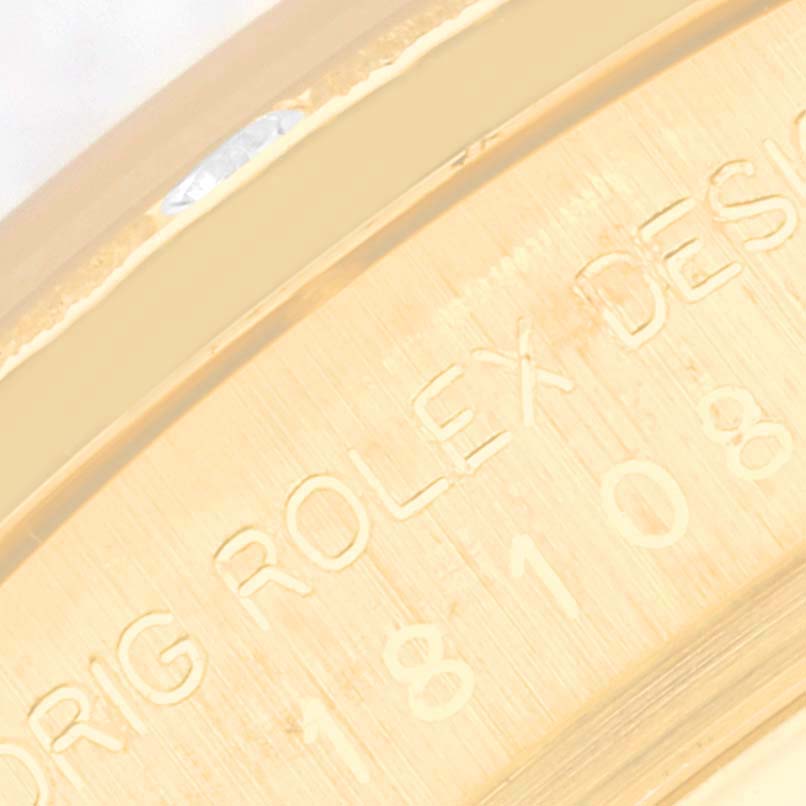 This image shows an angled close-up of the side or back of the Rolex President 18108 Men's Yellow Gold Black Dial 18108 Men's Yellow Gold Black Dial model, highlighting its engravings.