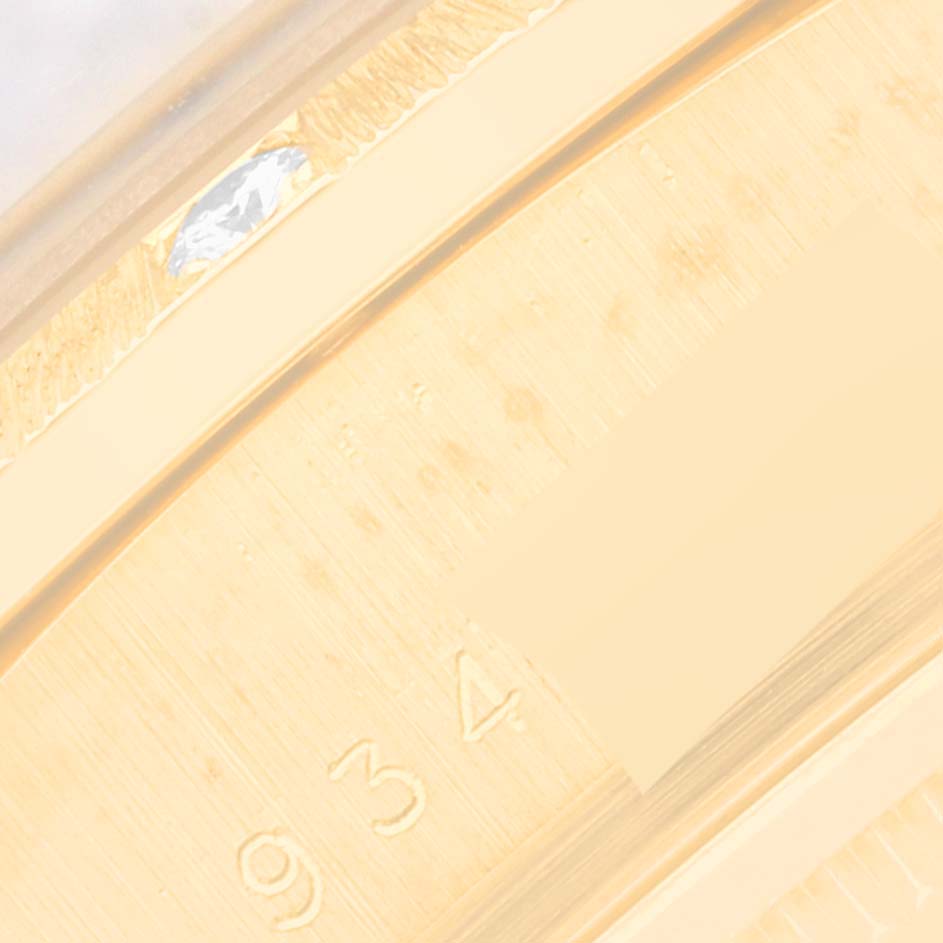 This is a close-up image of the side of a Rolex President 18108 Men's Yellow Gold Black Dial 18108 Men's Yellow Gold Black Dial model watch, showing part of the bracelet and a gem setting.