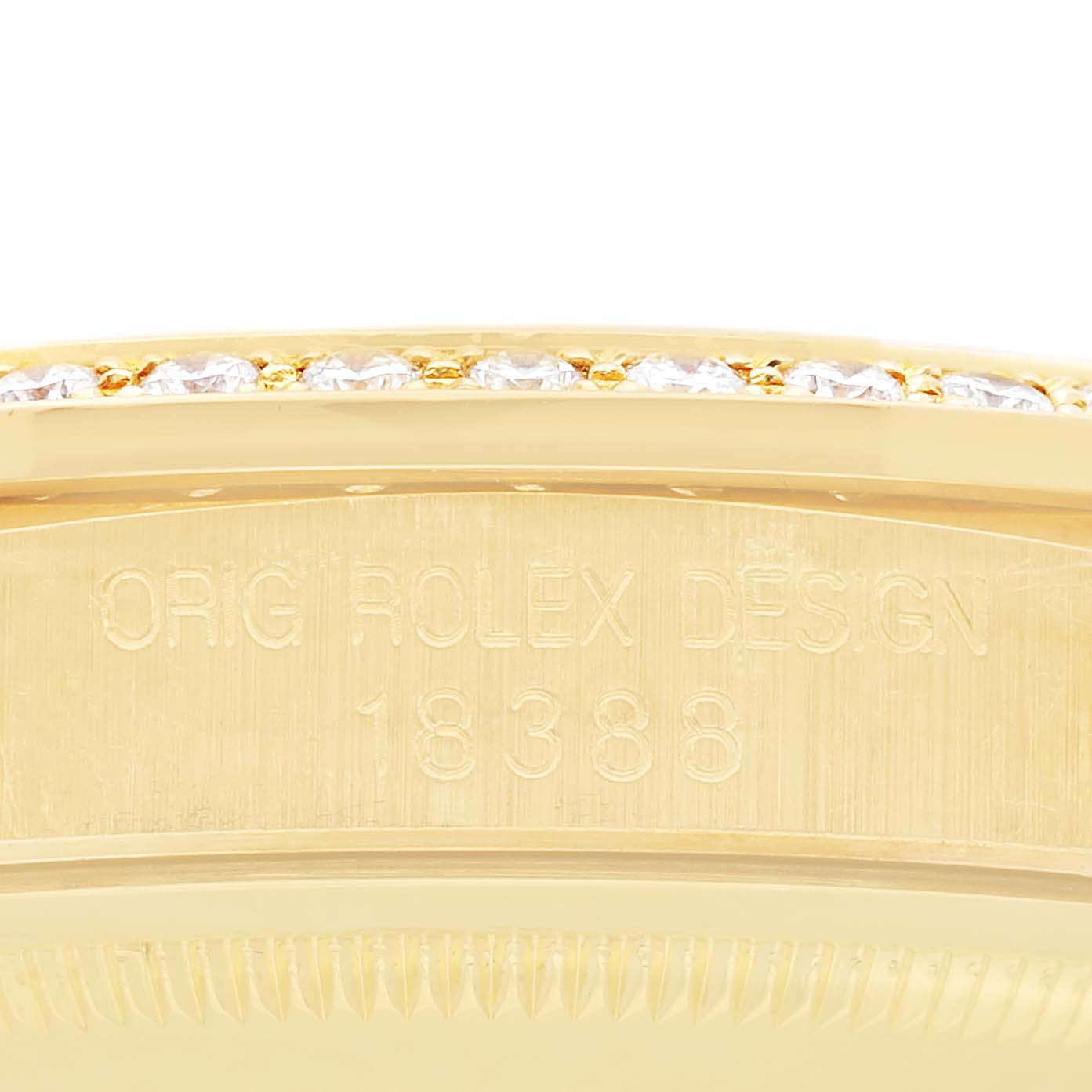 This image shows a close-up of the side casing and bezel of the Rolex President 18388 Men's Yellow Gold Champagne Dial 18388 Men's Yellow Gold Champagne Dial model, with engraved details visible.
