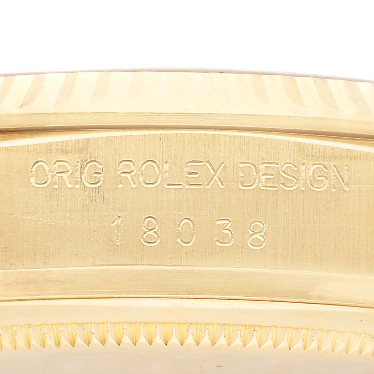 The image shows a close-up of the side of a Rolex President 18038 Men's Yellow Gold Silver Dial 18038 Men's Yellow Gold Silver Dial model, highlighting the engraved model number and design details.