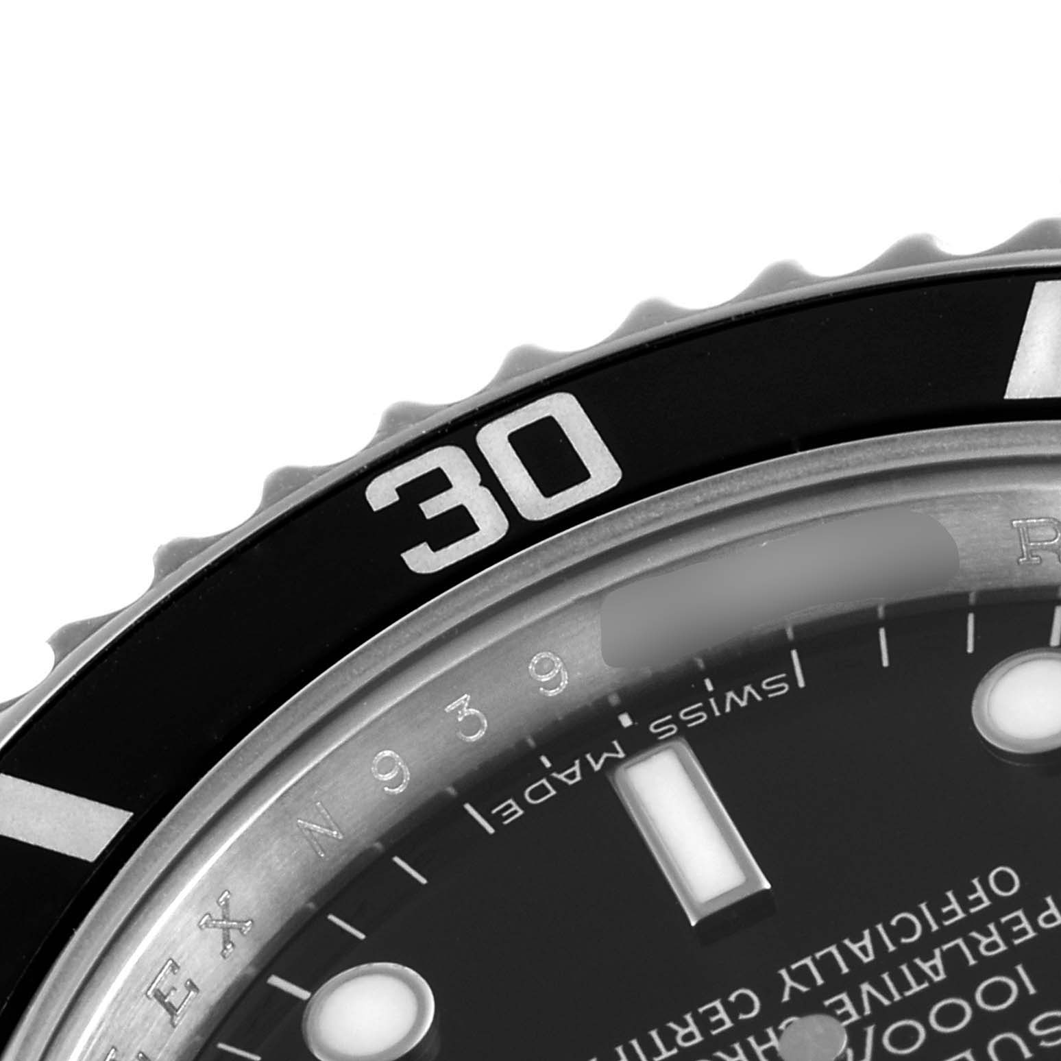 This image shows a close-up of the bezel and part of the dial of a Rolex Submariner 14060 Men's Stainless Steel Black Dial 14060 Men's Stainless Steel Black Dial watch.