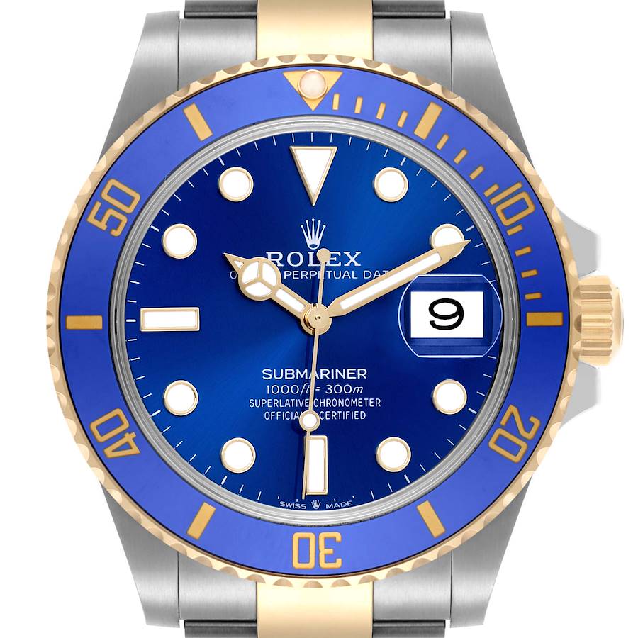 The image shows a front view of a Rolex Submariner watch, highlighting its blue dial, gold bezel, and date window at three o'clock.