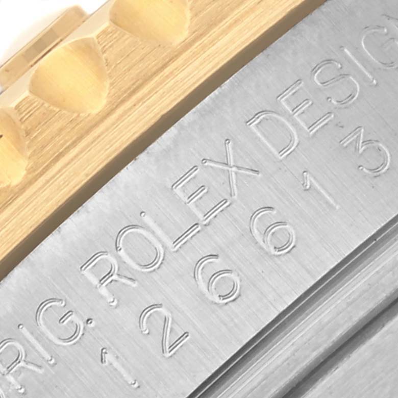 The image shows a close-up of the engraved side of a Rolex Submariner 126613LB Men's Steel and Gold (two tone) Blue Dial 126613LB Men's Steel and Gold (two tone) Blue Dial's case, with part of the bezel visible.