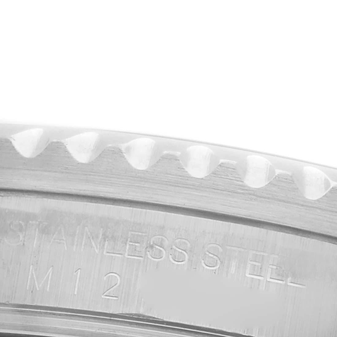 The image shows a close-up view of the stainless steel bezel edge and engraved inner case of a Rolex Submariner 16610 Men's Stainless Steel Black Dial 16610 Men's Stainless Steel Black Dial.