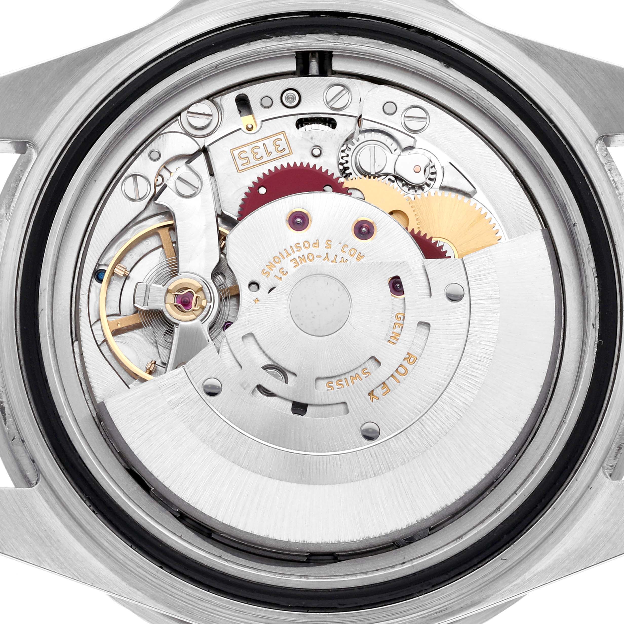 The image shows the internal mechanism of a Rolex Submariner 16610 Men's Stainless Steel Black Dial 16610 Men's Stainless Steel Black Dial watch from a top-down angle, highlighting gears and movement parts.