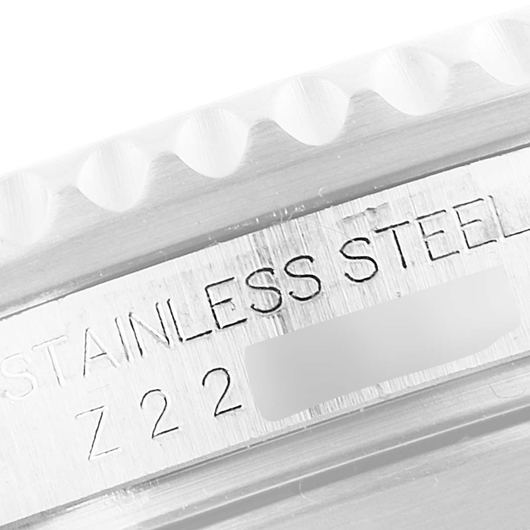 The image shows a close-up of the stainless steel casing and engraved text on a Rolex Submariner 16610LV Men
s Stainless Steel Black Dial 16610LV Men
s Stainless Steel Black Dial watch.