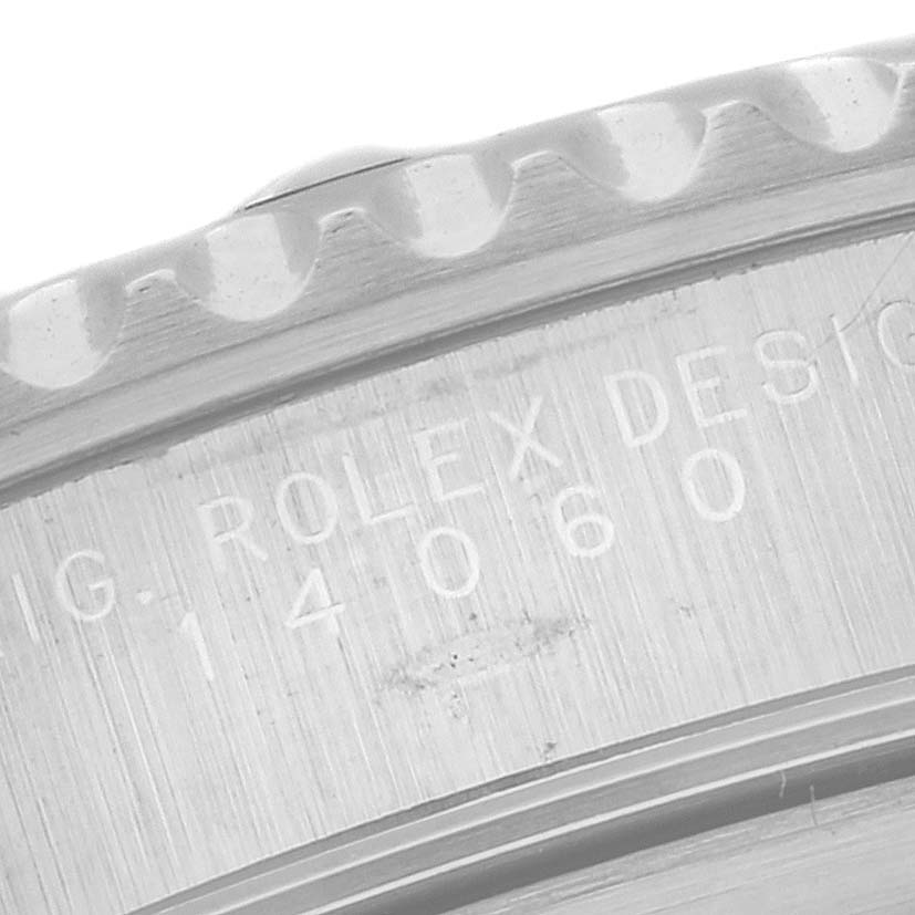 This close-up image shows the engraved serial number and part of the bezel on a Rolex Submariner 14060 Men
s Stainless Steel Black Dial 14060 Men
s Stainless Steel Black Dial watch.
