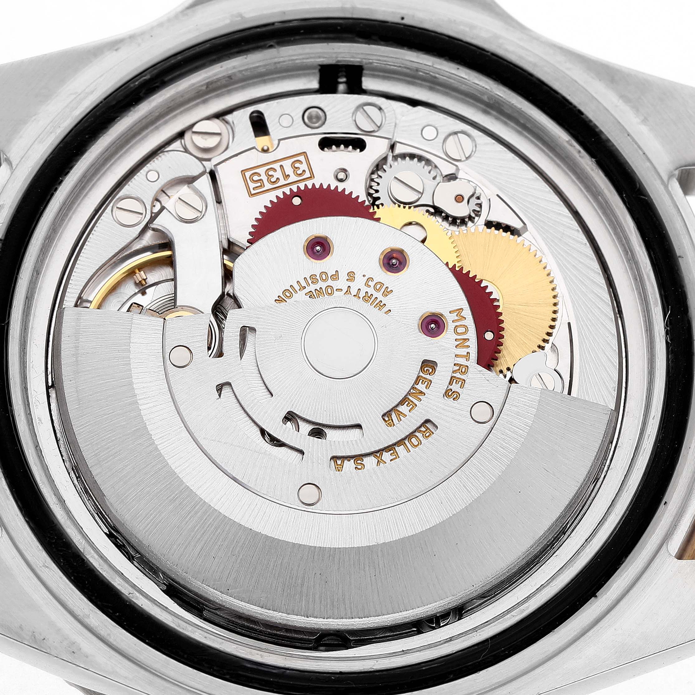 The image shows the movement of a Rolex Submariner 16613 Men's Steel and Gold (two tone) Champagne Dial from the back, revealing gears and the rotor mechanism.