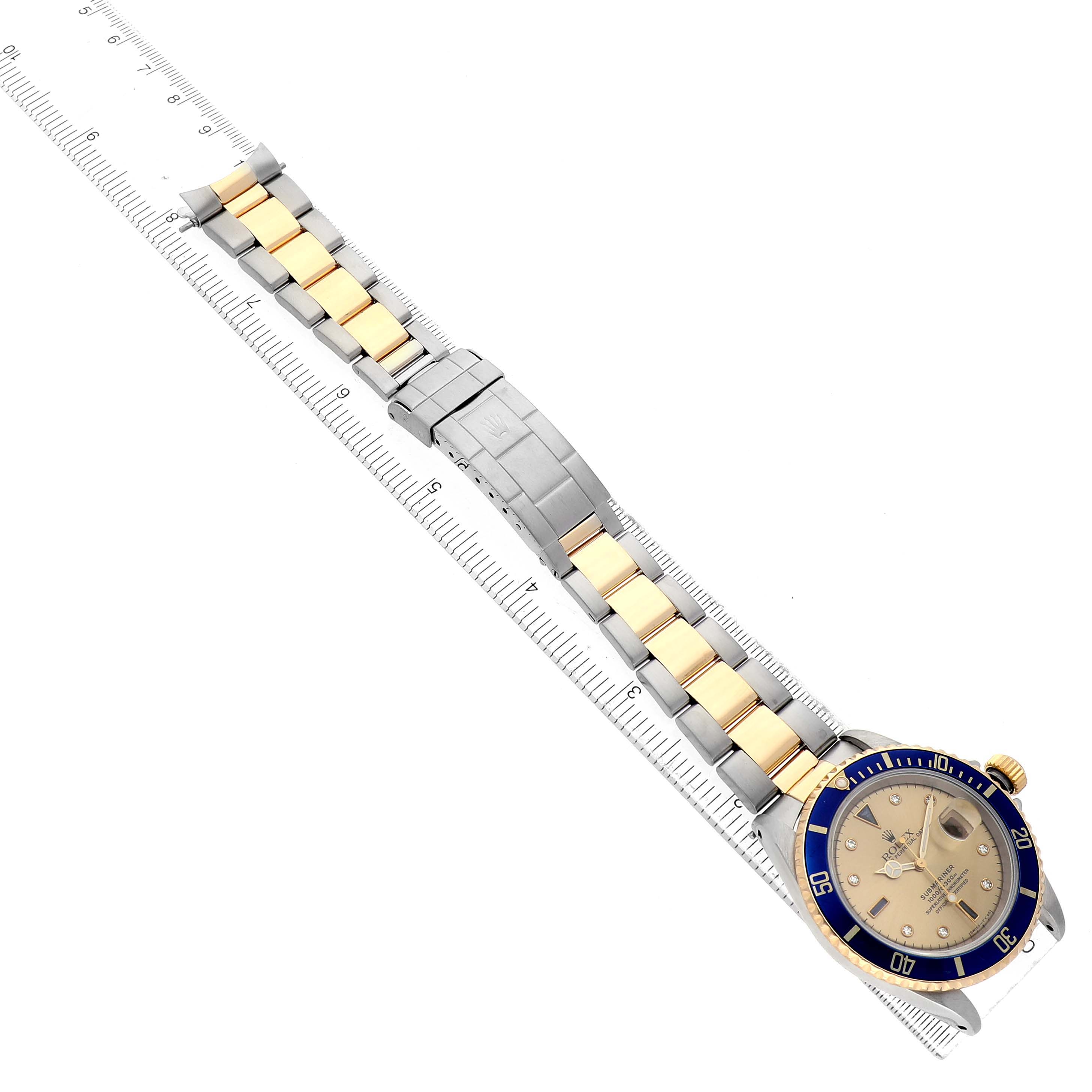 The Rolex Submariner 16613 Men's Steel and Gold (two tone) Champagne Dial watch is shown laid flat, displaying the full bracelet and face, with the bezel and crown visible.