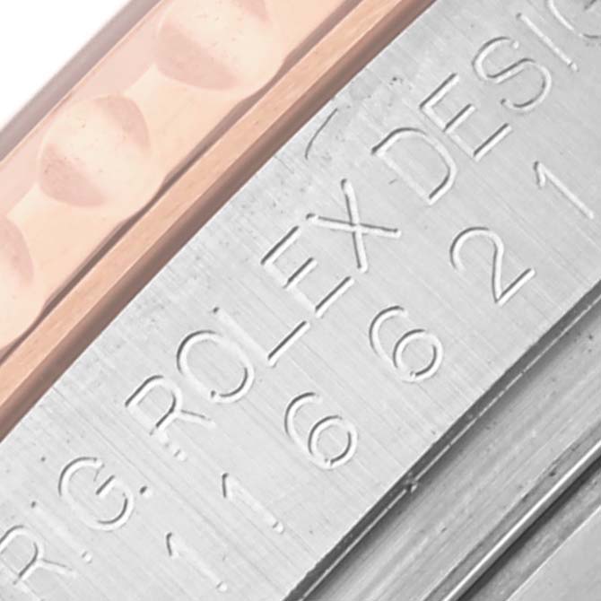 The image shows a close-up of the Rolex Yacht-Master 116621 Men's Steel and Gold (two tone) Brown Dial 116621 Men's Steel and Gold (two tone) Brown Dial's engraved case side, highlighting the metal texture and "Rolex Design" text.