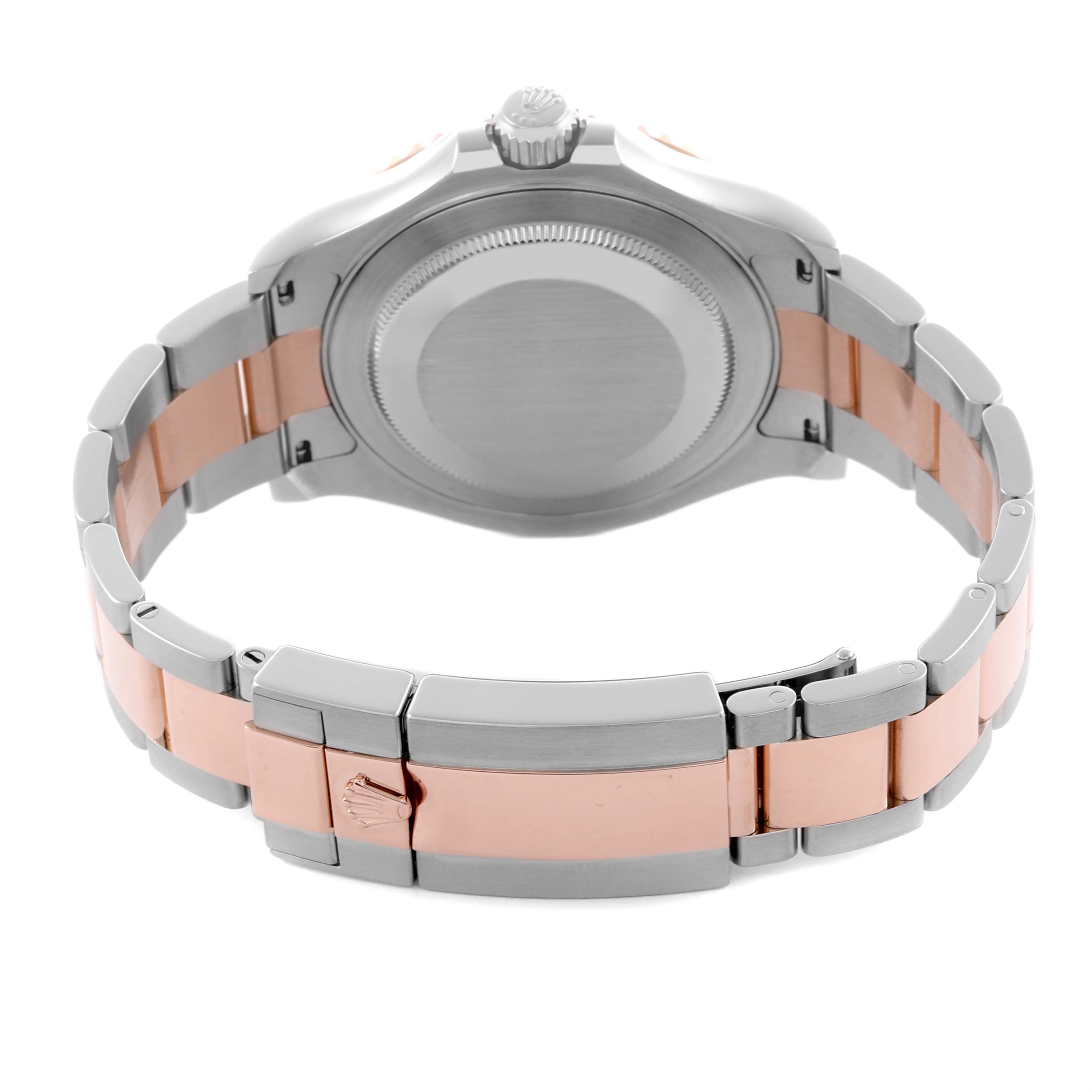 The image shows the back side of a Rolex Yacht-Master 116621 Men's Steel and Gold (two tone) Brown Dial 116621 Men's Steel and Gold (two tone) Brown Dial watch, focusing on the case back and bracelet clasp.