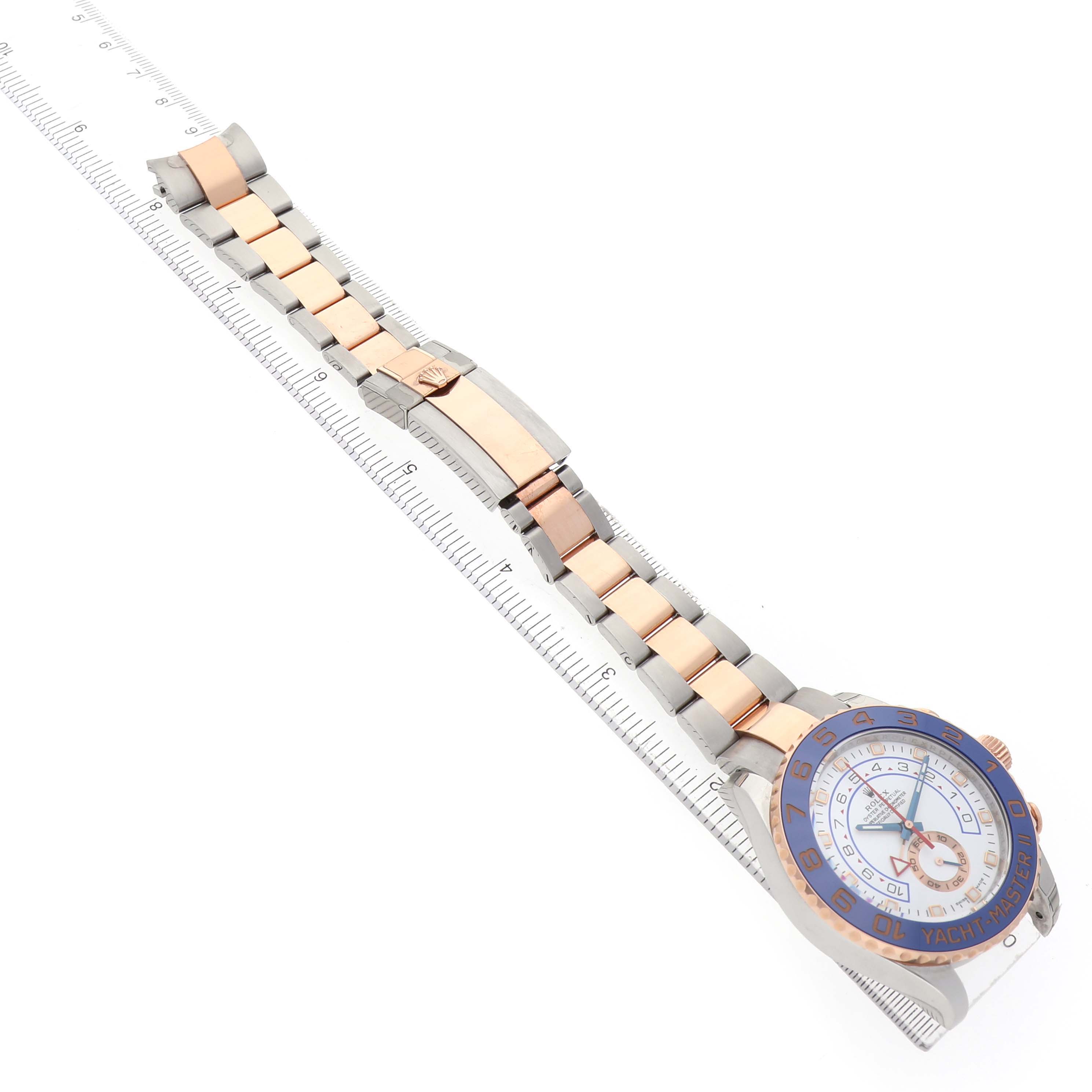 The Rolex Yacht-Master 116681M Men's Steel and Gold (two tone) White Dial watch is shown from an angled side view, displaying the bracelet, clasp, and partial face.