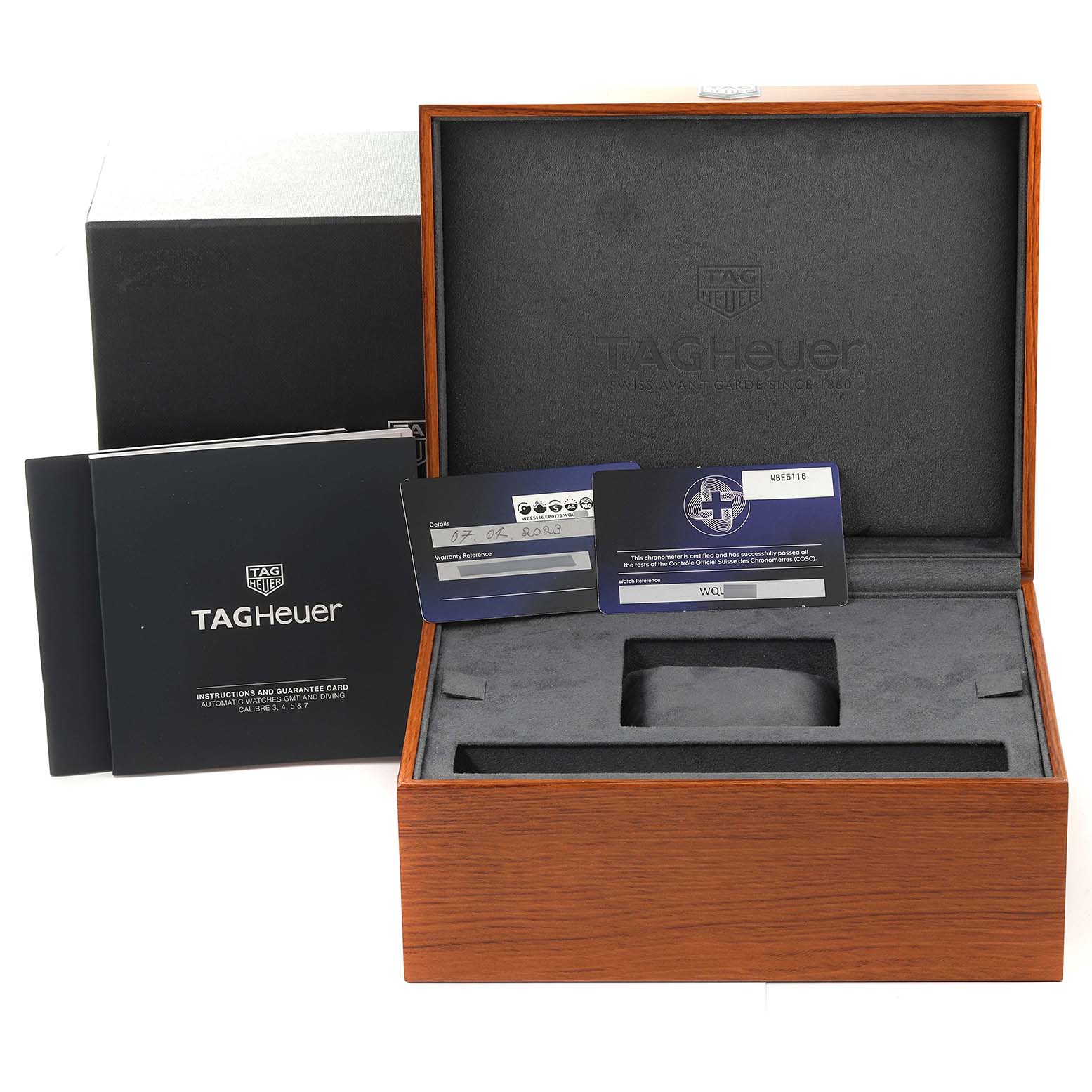 The image shows the packaging and accessories of a Tag Heuer Autavia WBE5116.EB0173 Men's Stainless Steel Blue Dial WBE5116.EB0173 Men's Stainless Steel Blue Dial, including the watch box, instruction manuals, and warranty cards.