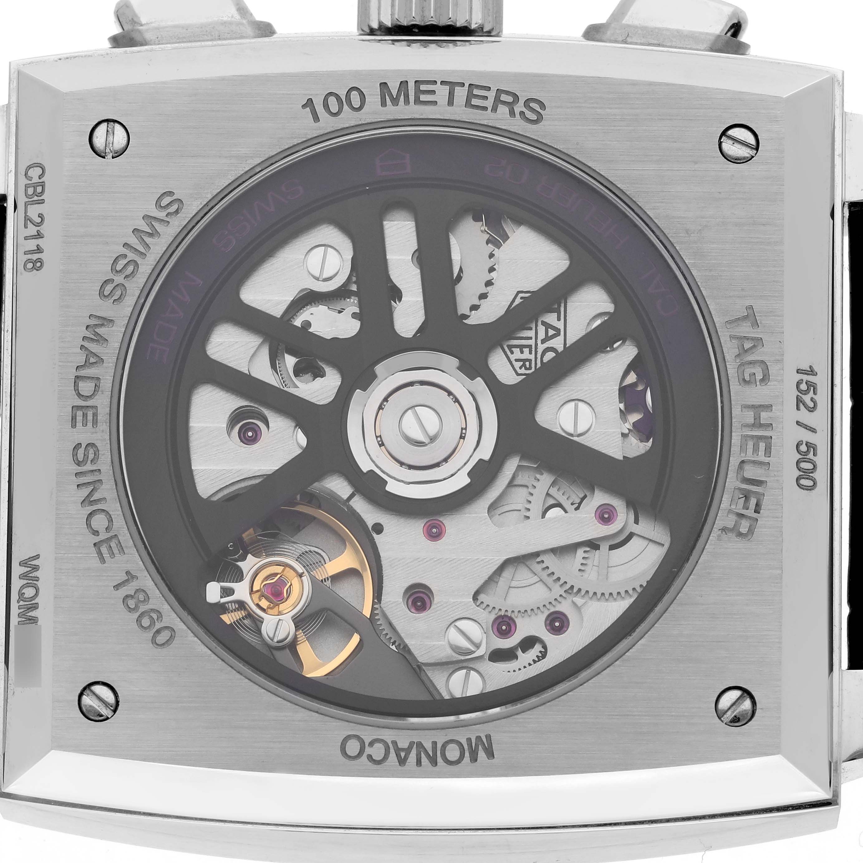 The Monaco model by Tag Heuer is shown from the back, displaying its intricate movement and rotor details.