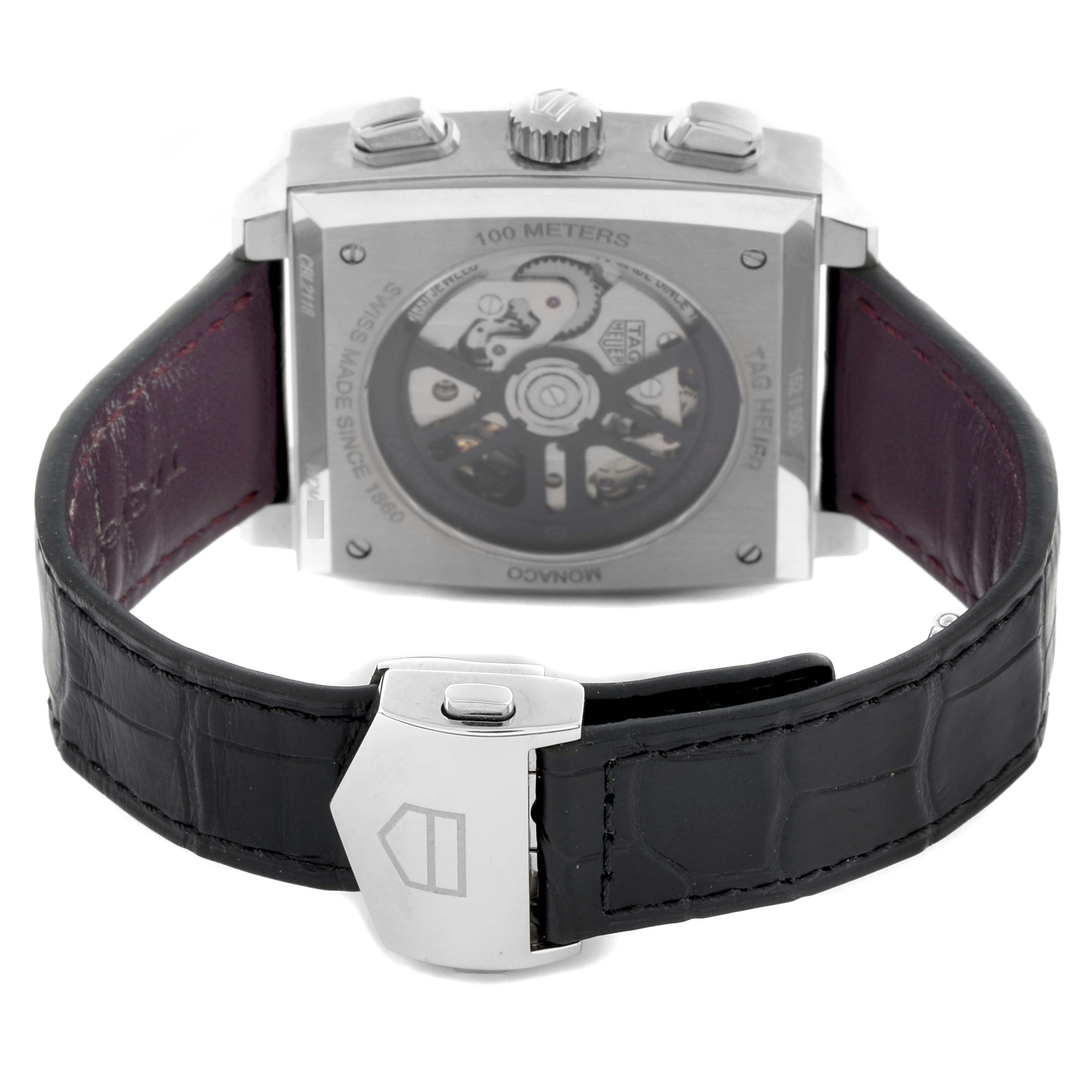 The Tag Heuer Monaco CBL2118.FC6518 Men's Stainless Steel Purple Dial CBL2118.FC6518 Men's Stainless Steel Purple Dial watch is shown from the back, highlighting its transparent case back and strap clasp.