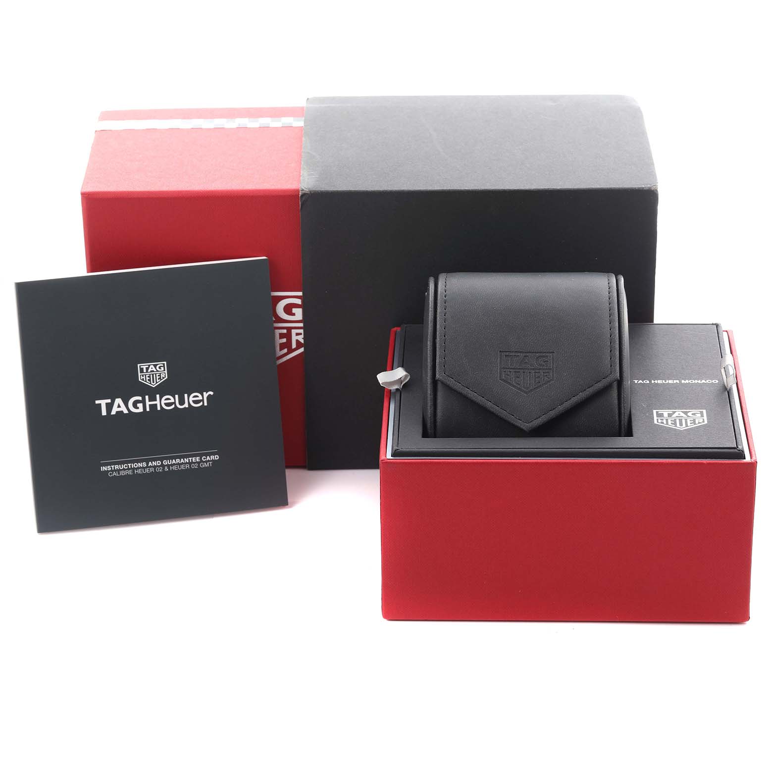 The image shows a Tag Heuer Monaco CBL2118.FC6518 Men's Stainless Steel Purple Dial CBL2118.FC6518 Men's Stainless Steel Purple Dial watch box, case, and manual at a slightly elevated angle.