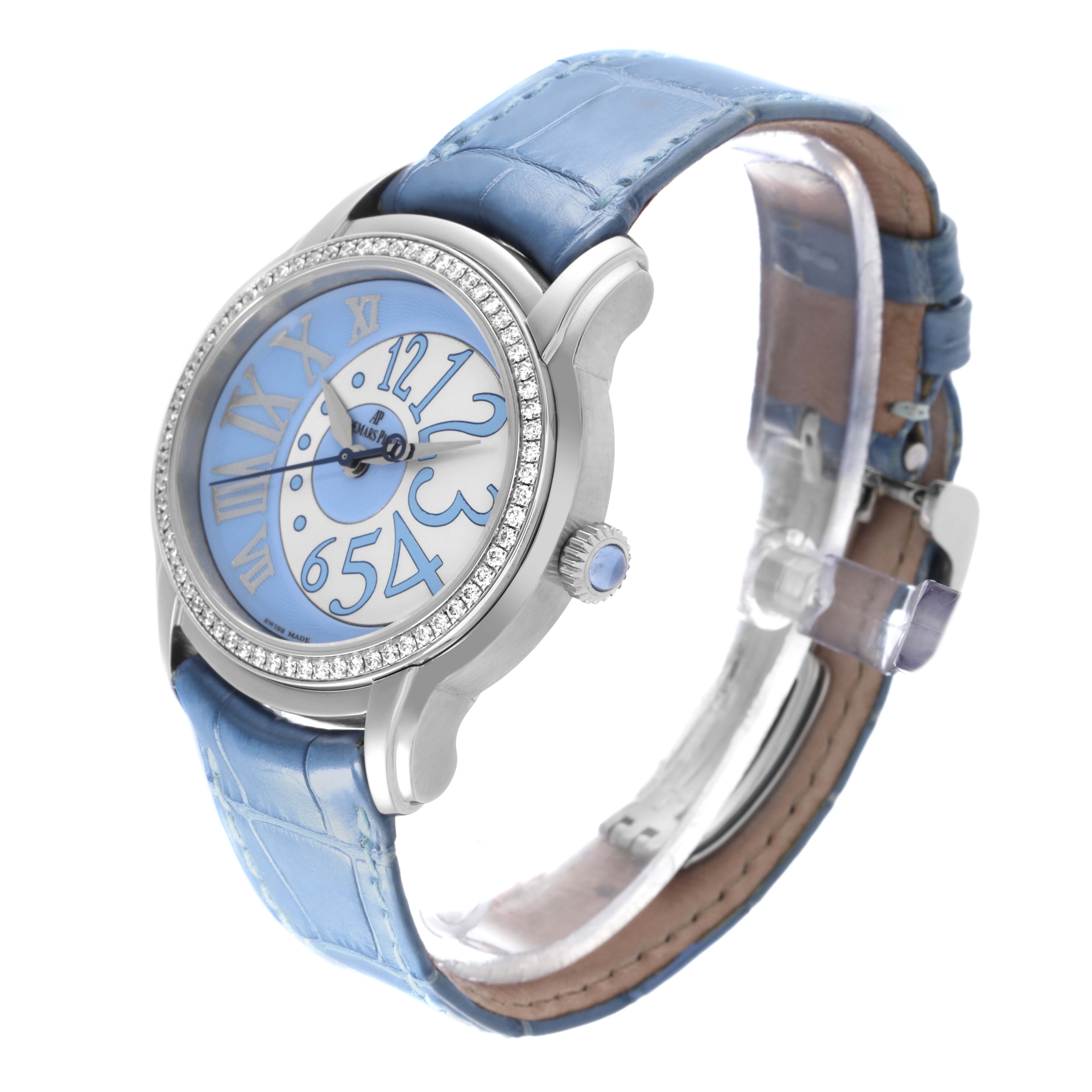 The Audemars Piguet Millenary 77301ST.ZZ.D303CR.01 Women's White Gold Blue Dial 77301ST.ZZ.D303CR.01 Women's White Gold Blue Dial watch is shown at a three-quarter angle, displaying the face, side crown, and blue leather strap.