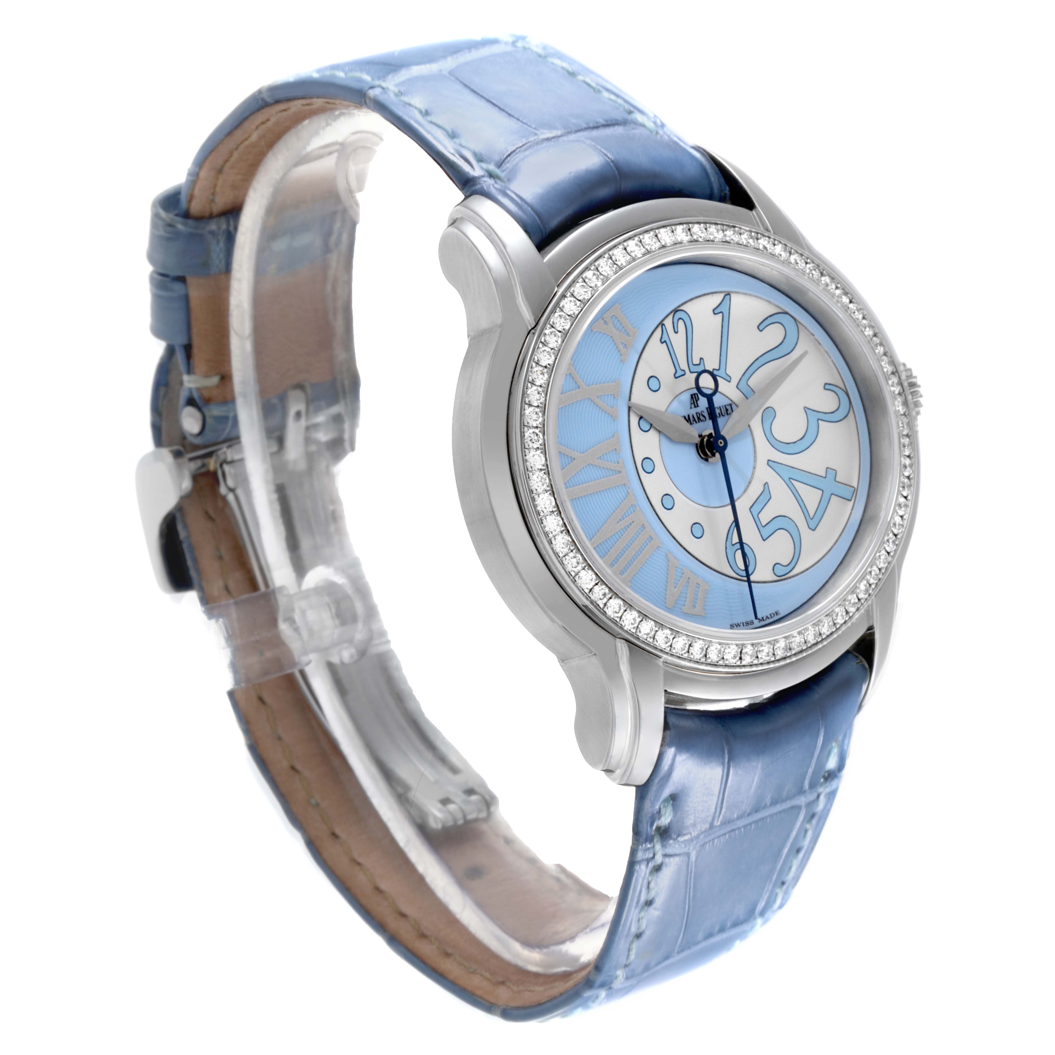 The Audemars Piguet Millenary 77301ST.ZZ.D303CR.01 Women's White Gold Blue Dial 77301ST.ZZ.D303CR.01 Women's White Gold Blue Dial watch is shown at a three-quarter angle, displaying the face, bezel, and blue leather strap.