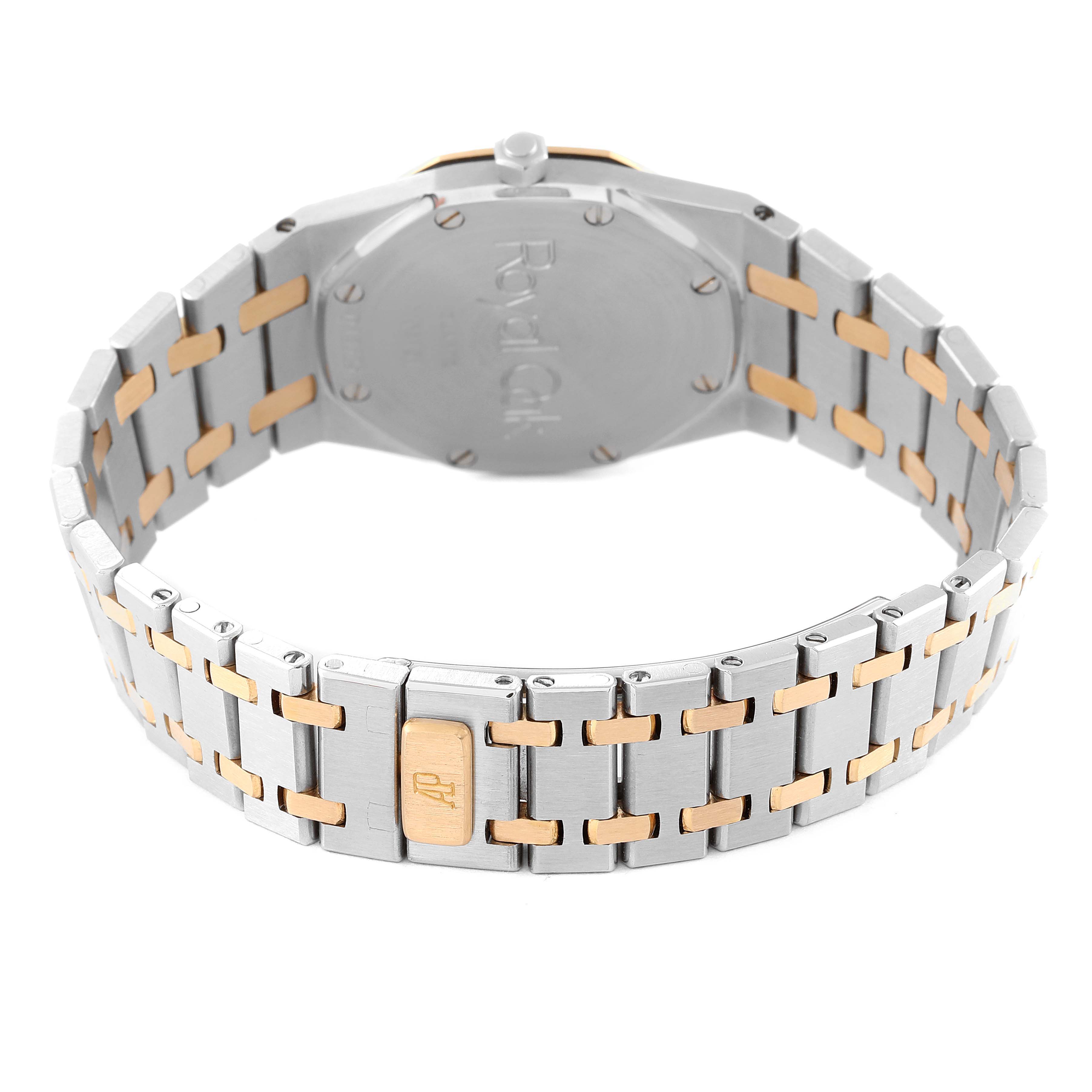 The image shows the back and bracelet of a Royal Oak watch by Audemars Piguet, highlighting the clasp with the AP logo.