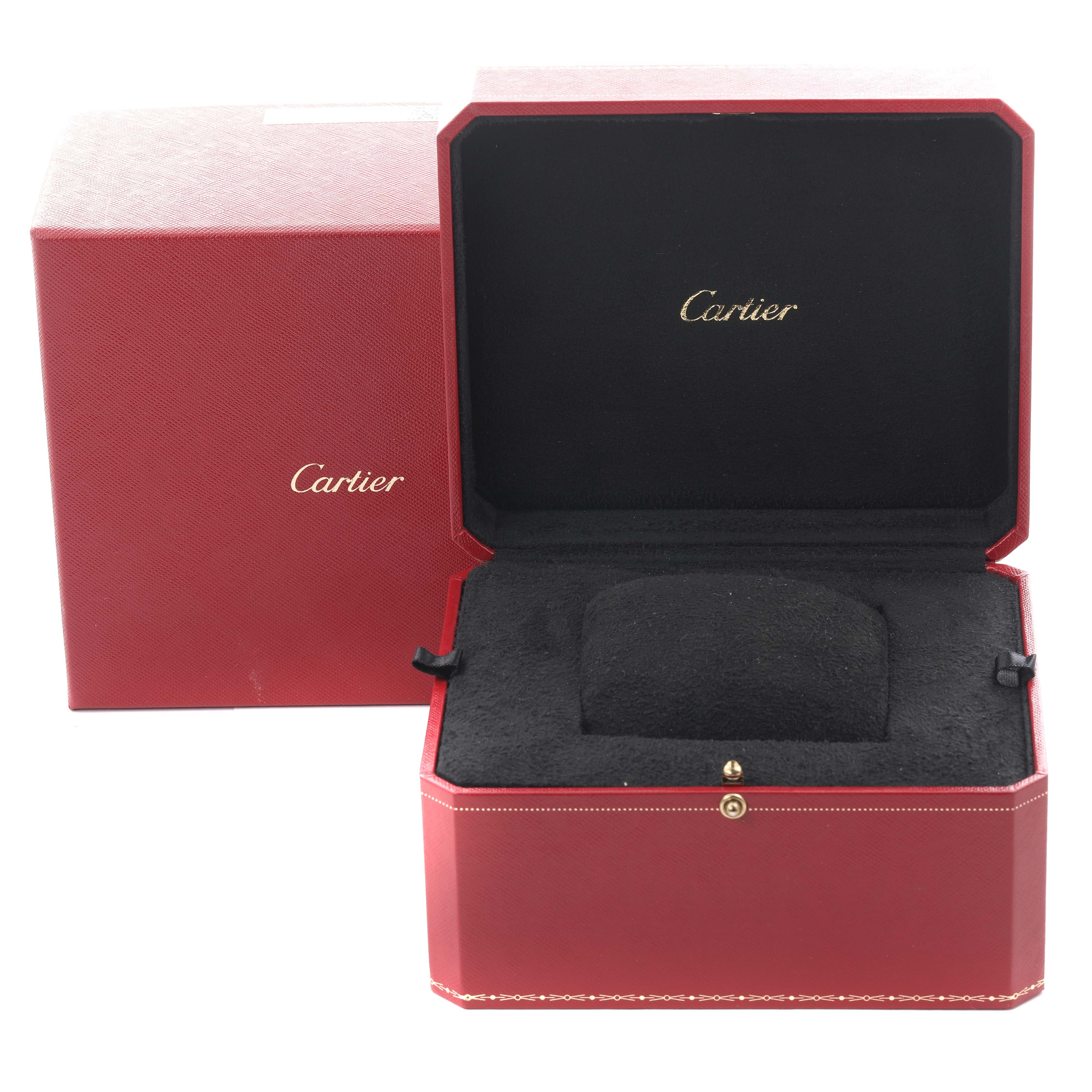 The image shows an open Cartier Santos W2SA0009 Men's Steel and Gold (two tone) Silver Dial W2SA0009 Men's Steel and Gold (two tone) Silver Dial watch box at a slight angle, revealing its black interior and red exterior with the Cartier logo.