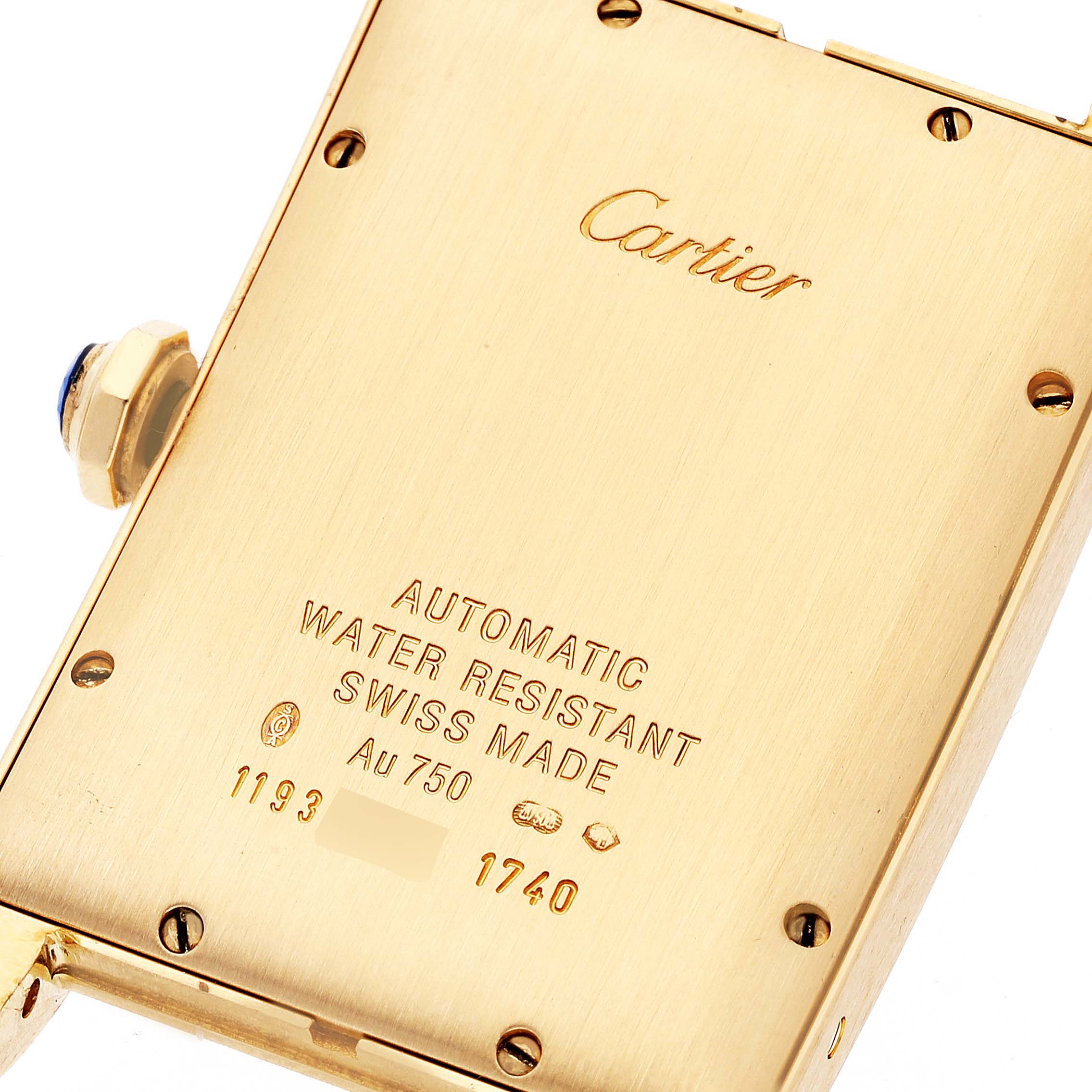 The image shows the back of a Cartier Tank Americaine W2603156 Men
s Yellow Gold Silver Dial W2603156 Men
s Yellow Gold Silver Dial watch, highlighting engravings and the crown.