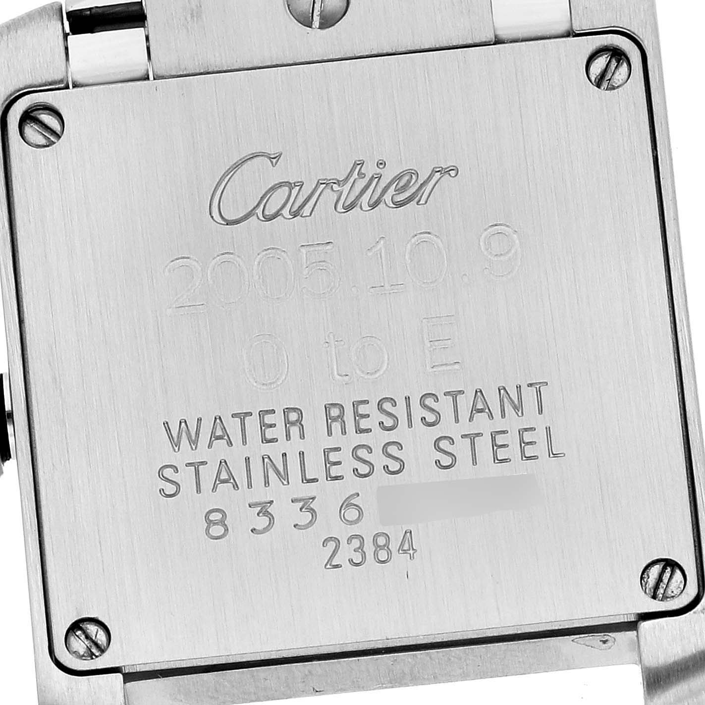 This image shows the stainless steel back case of a Cartier Tank Française watch, displaying its engraved details.