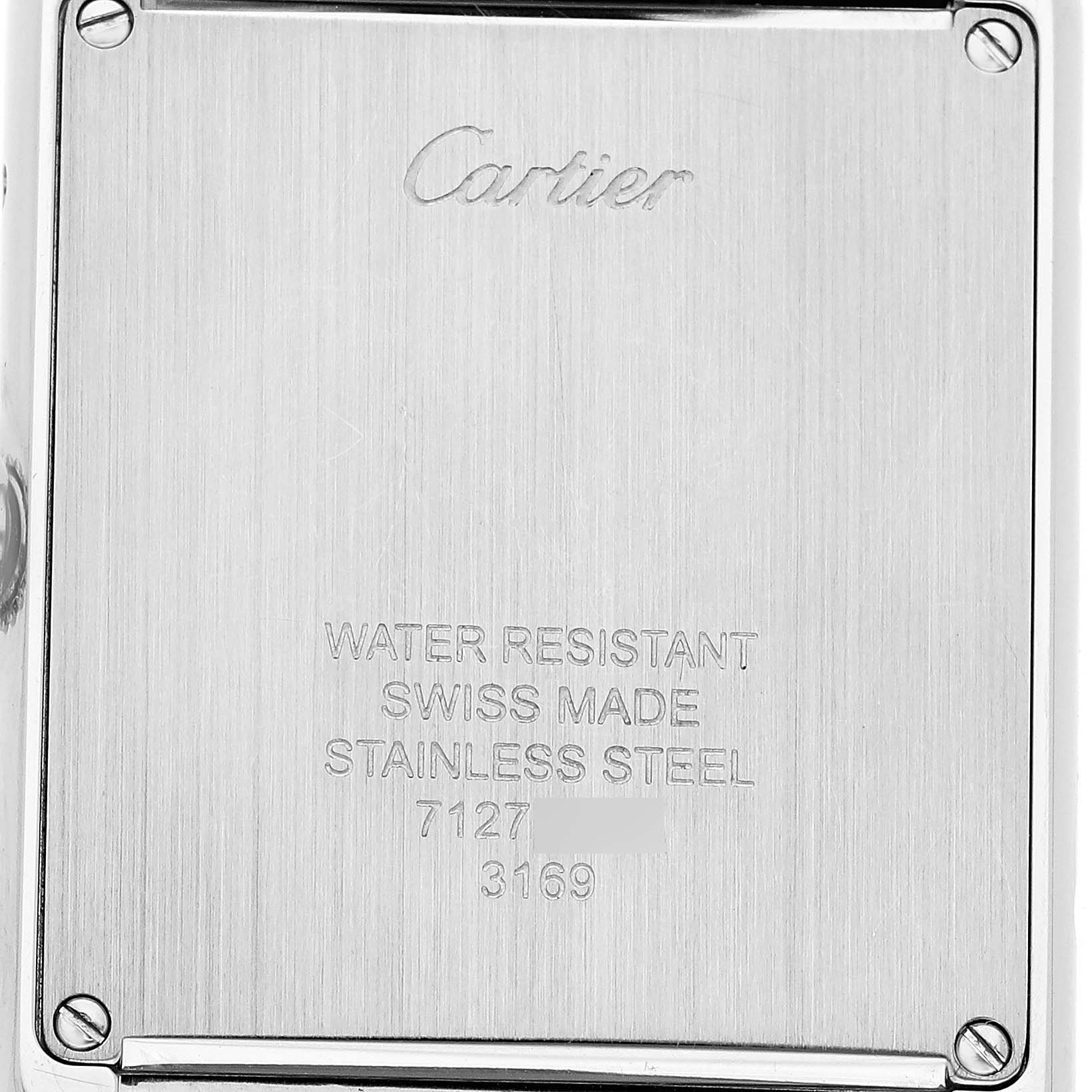 The image shows the back case of a Cartier Tank Solo WSTA0028 Women's Stainless Steel White Dial watch, featuring engravings like "water resistant" and "Swiss made."