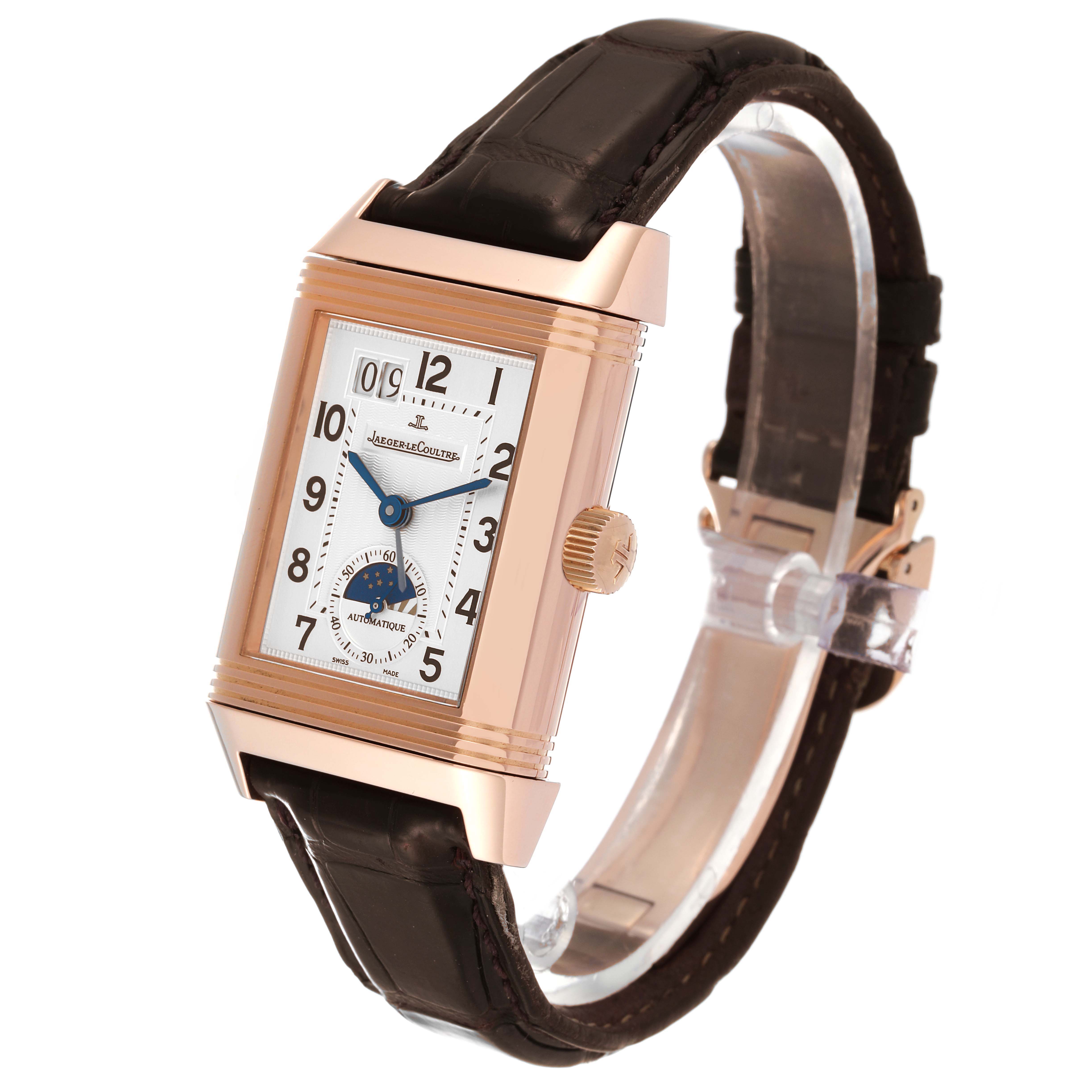 The Jaeger-LeCoultre Reverso watch is shown at a slight side angle, highlighting the face, crown, and leather strap.