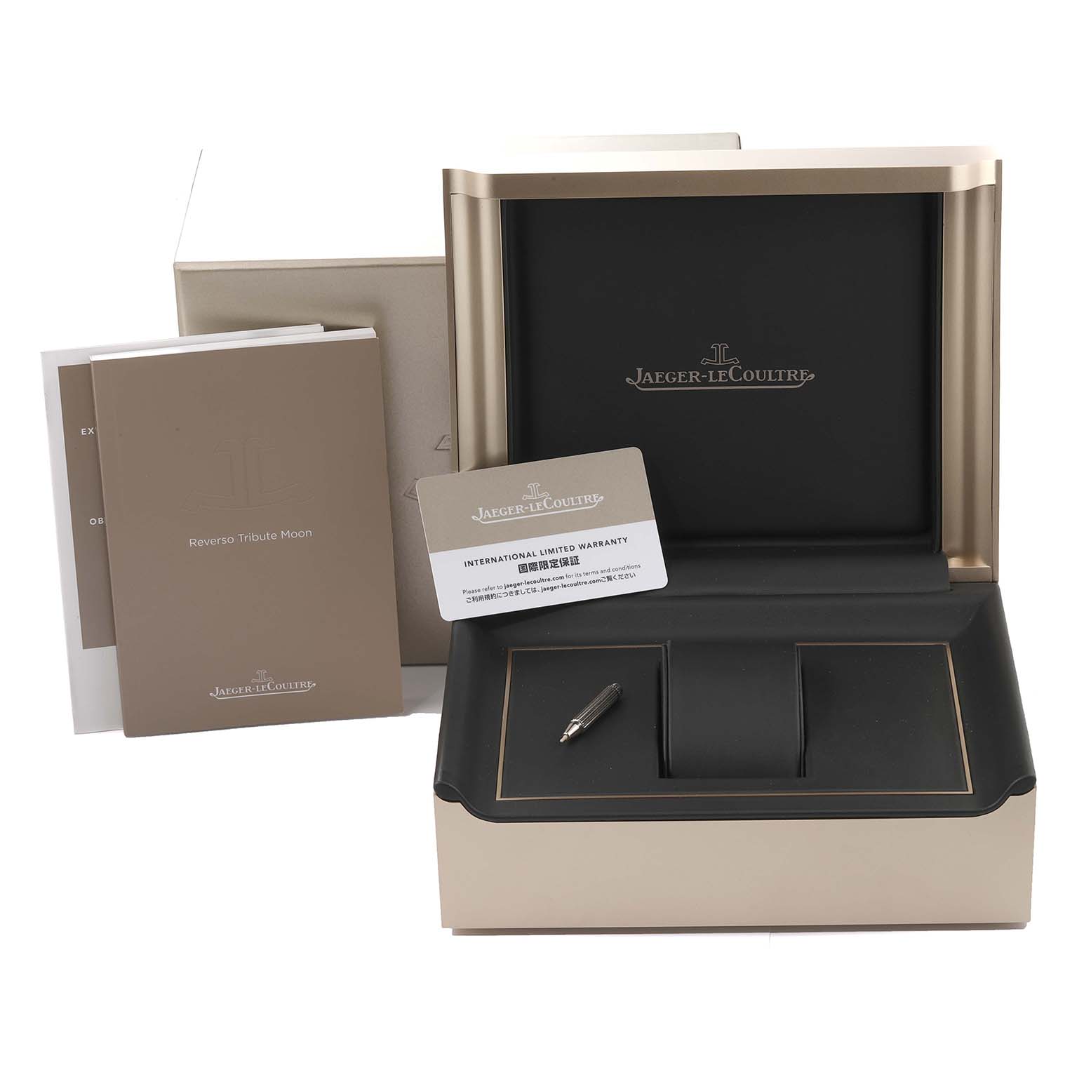 The image shows the box, international warranty card, booklets, and pen for the Jaeger-LeCoultre Reverso model.