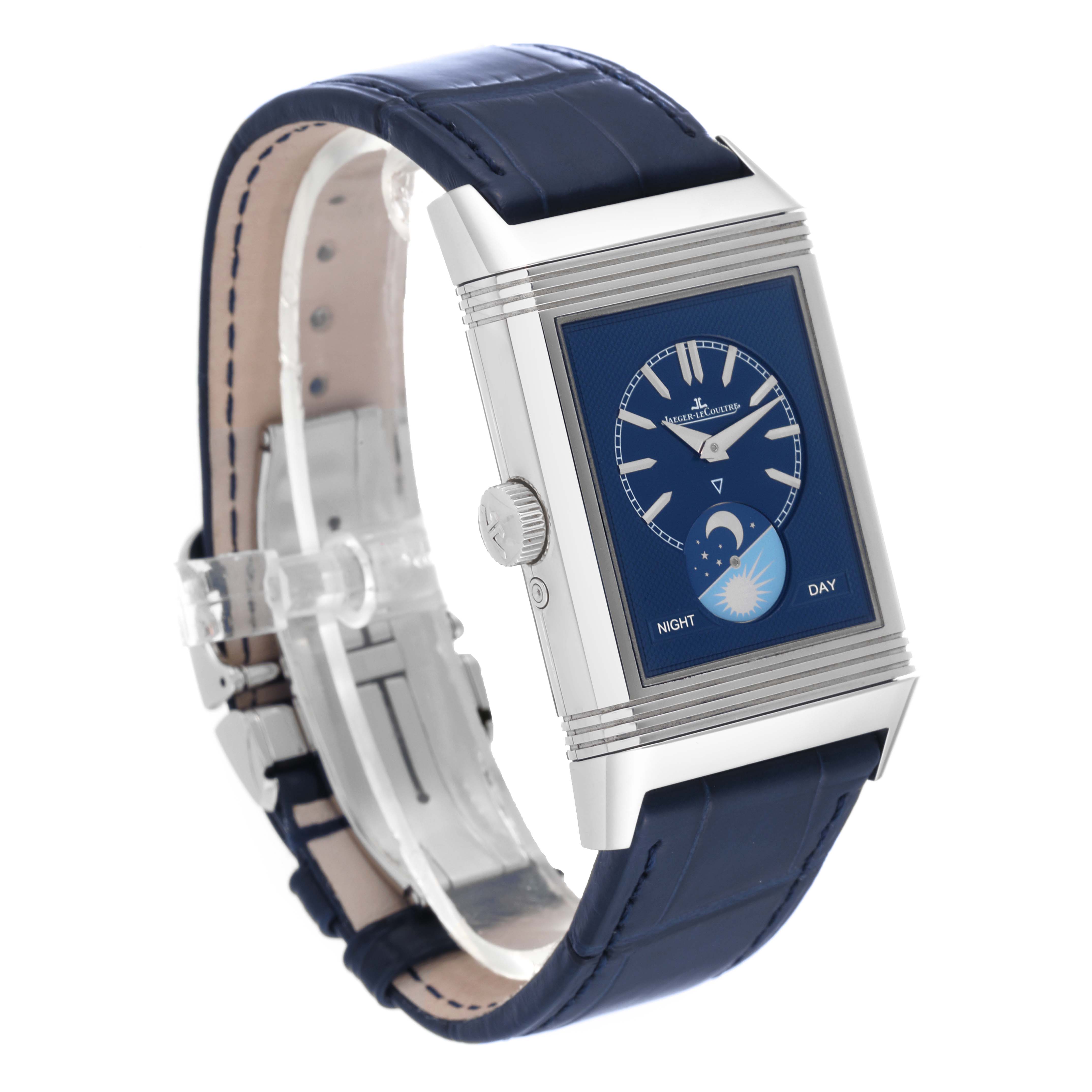 The Jaeger-LeCoultre Reverso watch is shown at a three-quarter angle, displaying its blue face, side crown, and blue leather strap.