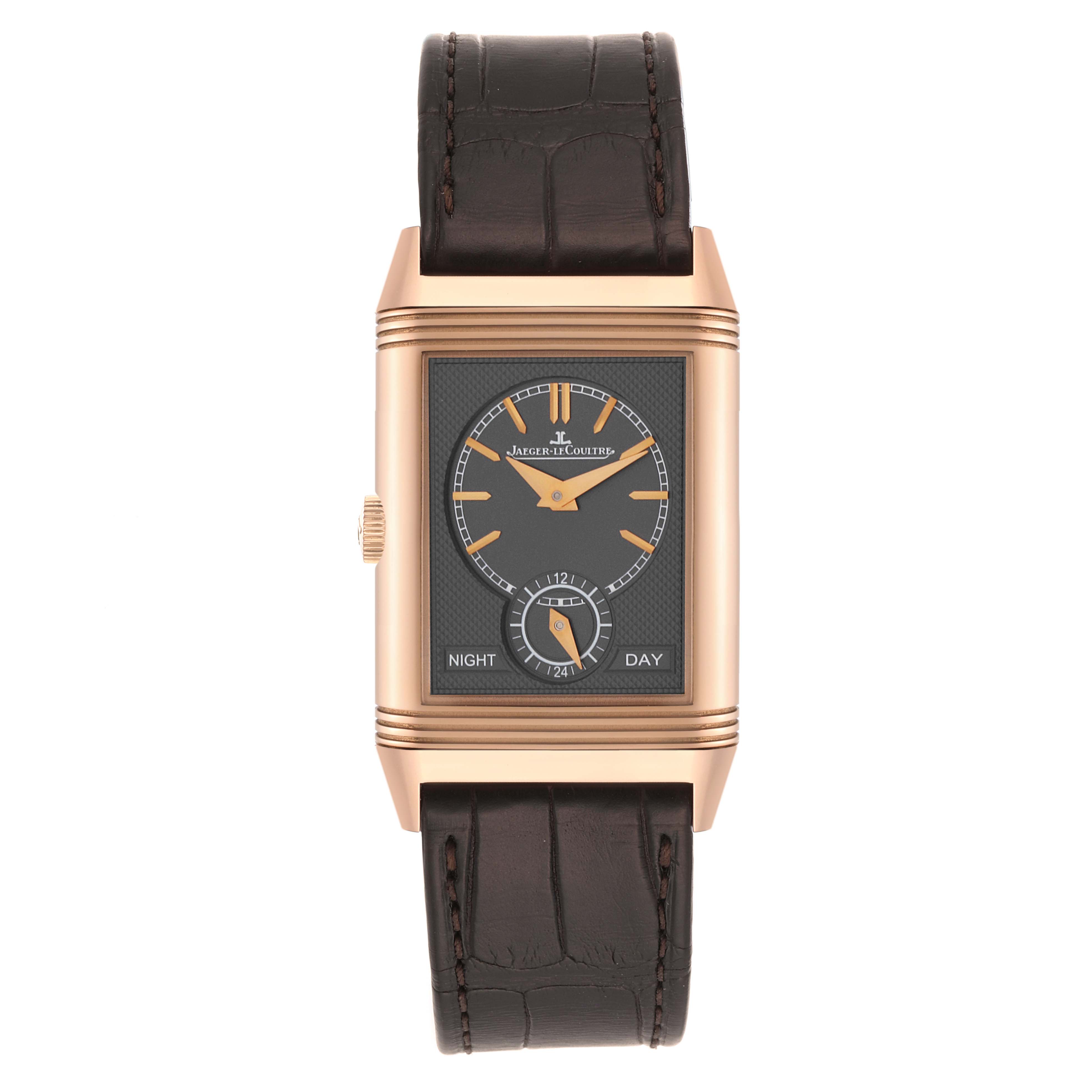 The Jaeger-LeCoultre Reverso watch is shown from the front, displaying its rectangular dial and dark brown leather strap.