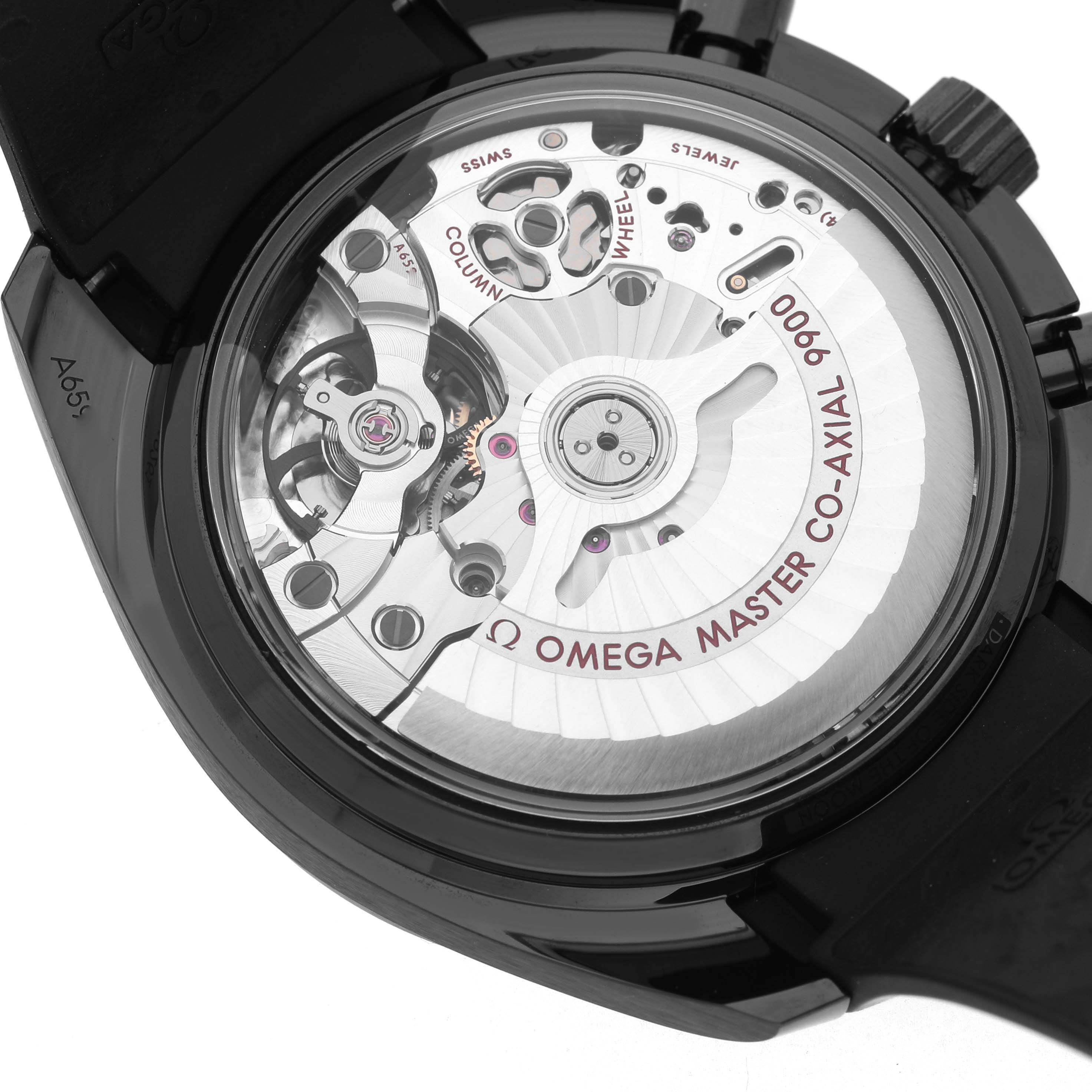 The image shows the back view of an Omega Speedmaster 310.92.44.51.01.004 Men's Ceramic Black Dial, displaying its intricate movement and components.