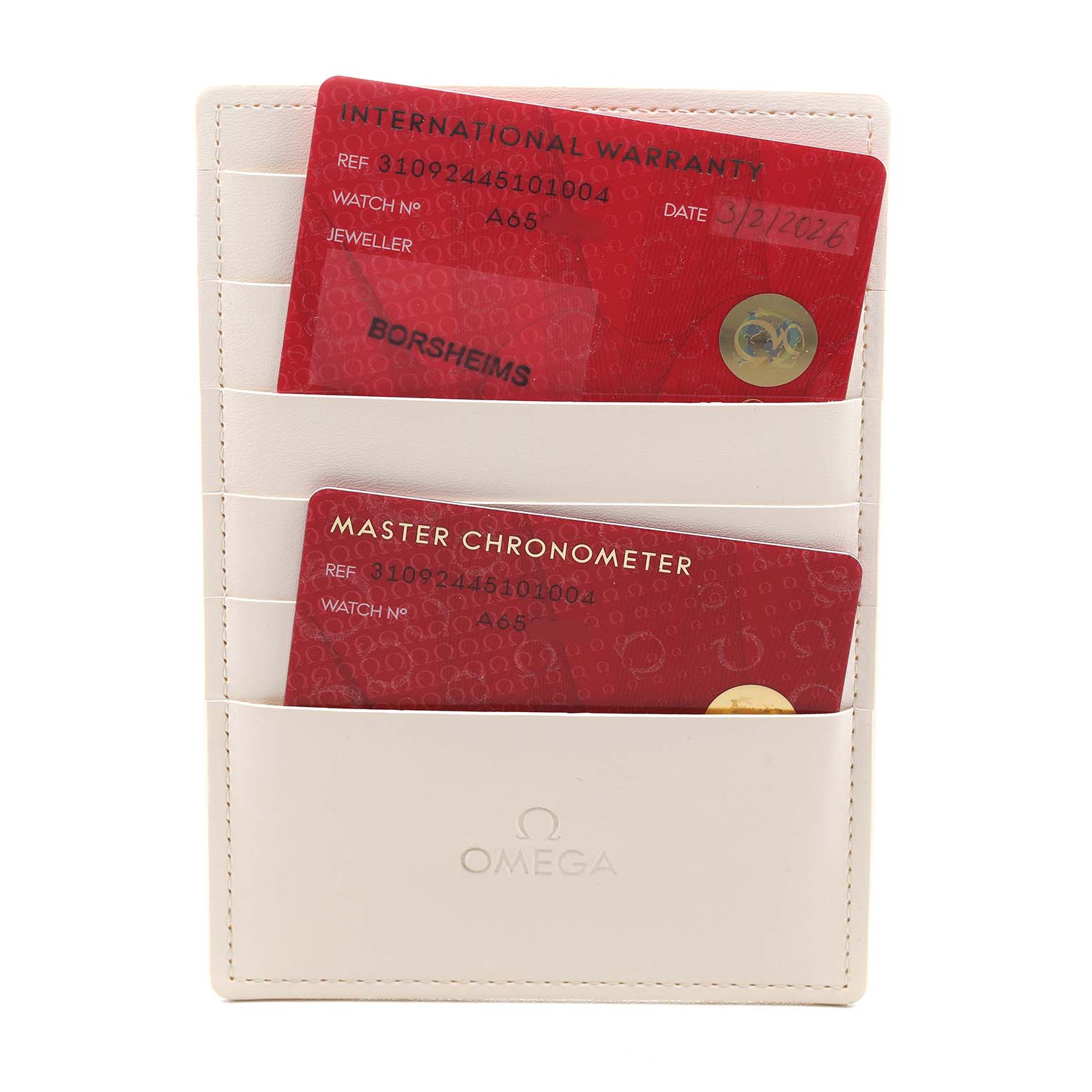 The image shows warranty and chronometer cards for an Omega Speedmaster 310.92.44.51.01.004 Men's Ceramic Black Dial, placed in a white cardholder.