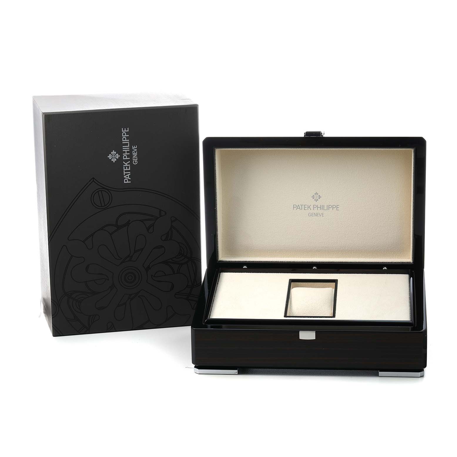 The image shows the open box and packaging for the Patek Philippe Gondolo 5135P Men's Platinum Grey Dial watch, highlighting its luxurious presentation.