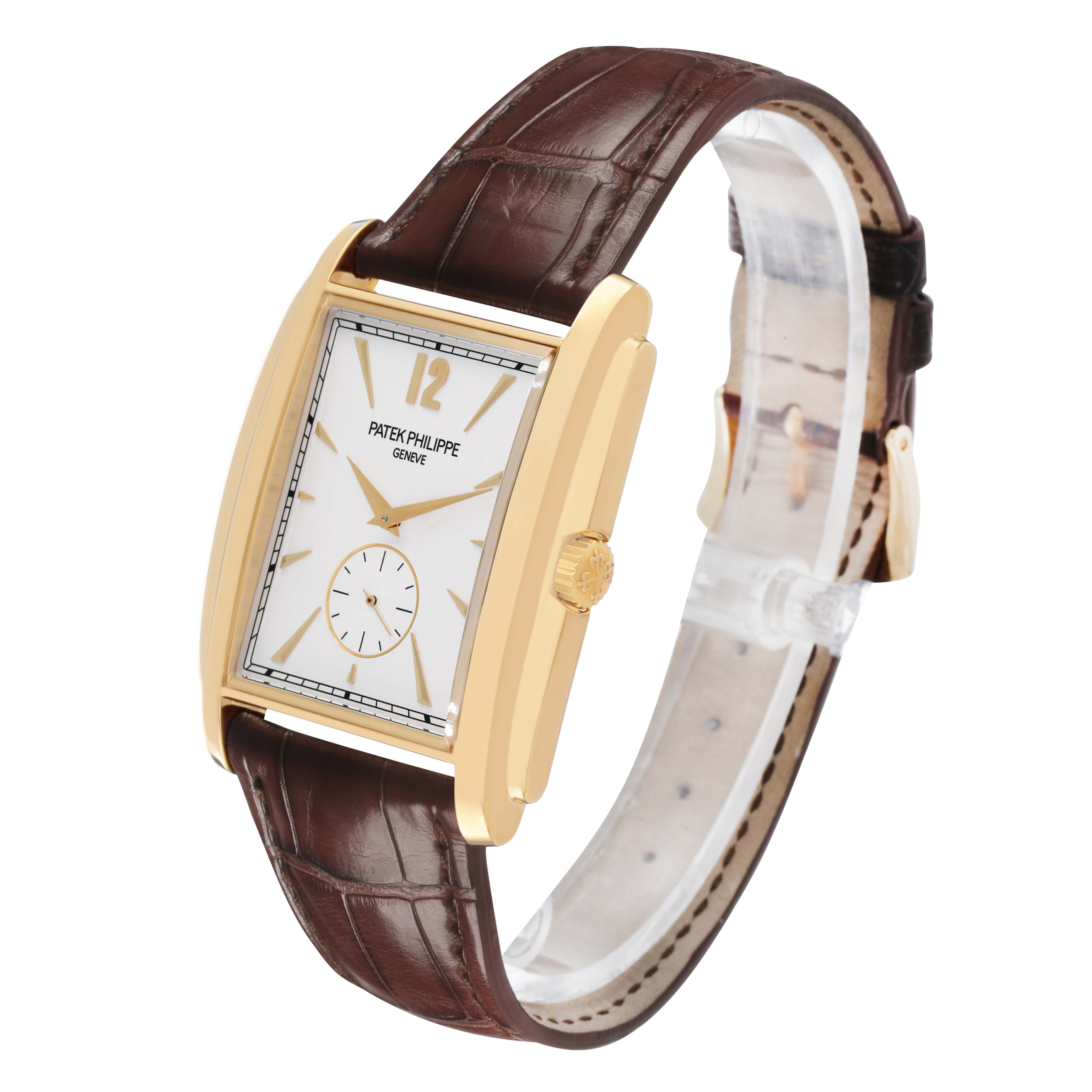 The Patek Philippe Gondolo 5124J-001 Men's Yellow Gold Silver Dial watch is shown at an angle highlighting its gold case, white dial, brown leather strap, and side crown.