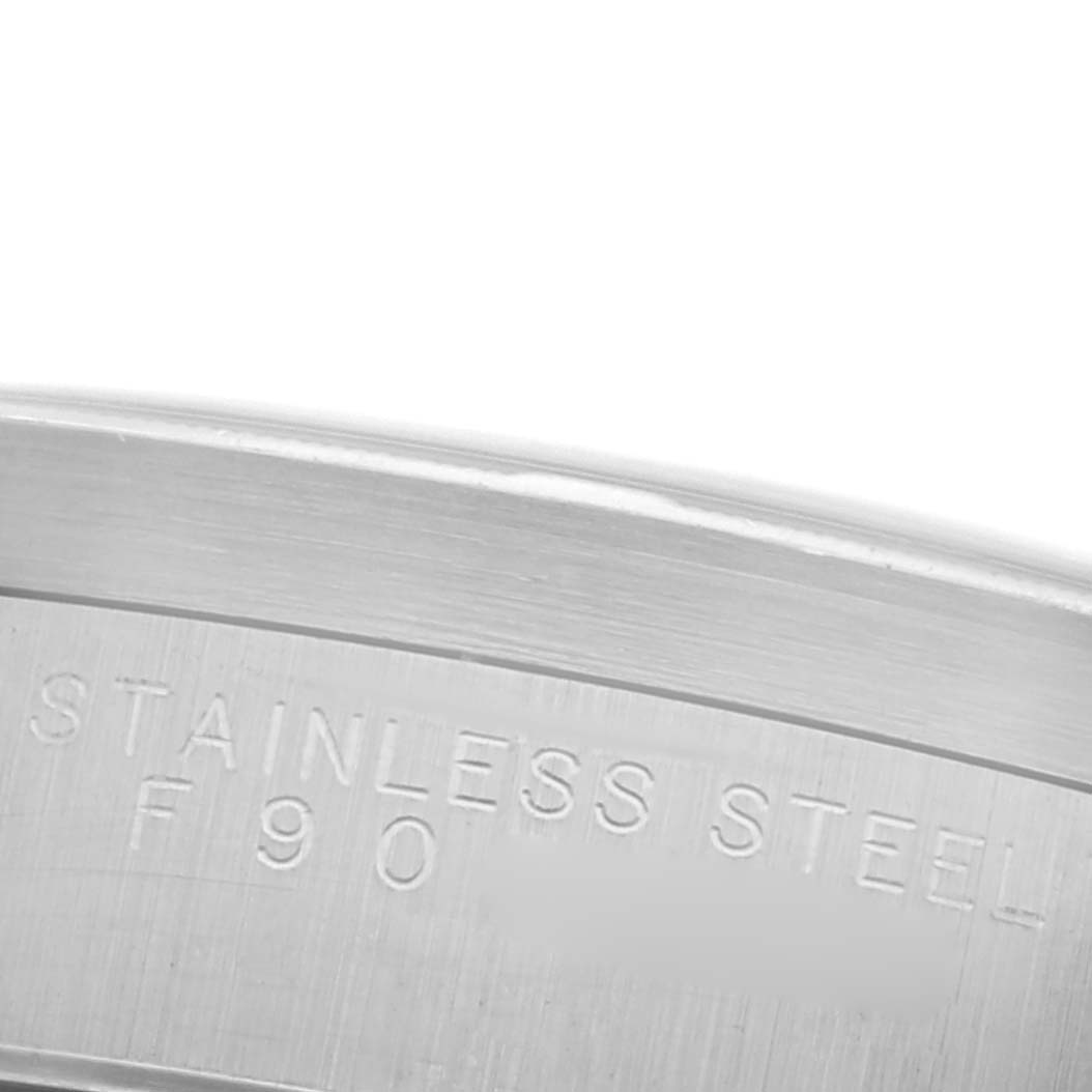 The image shows a close-up of the side of the case back of a Rolex Datejust, highlighting the "Stainless Steel" engraving.