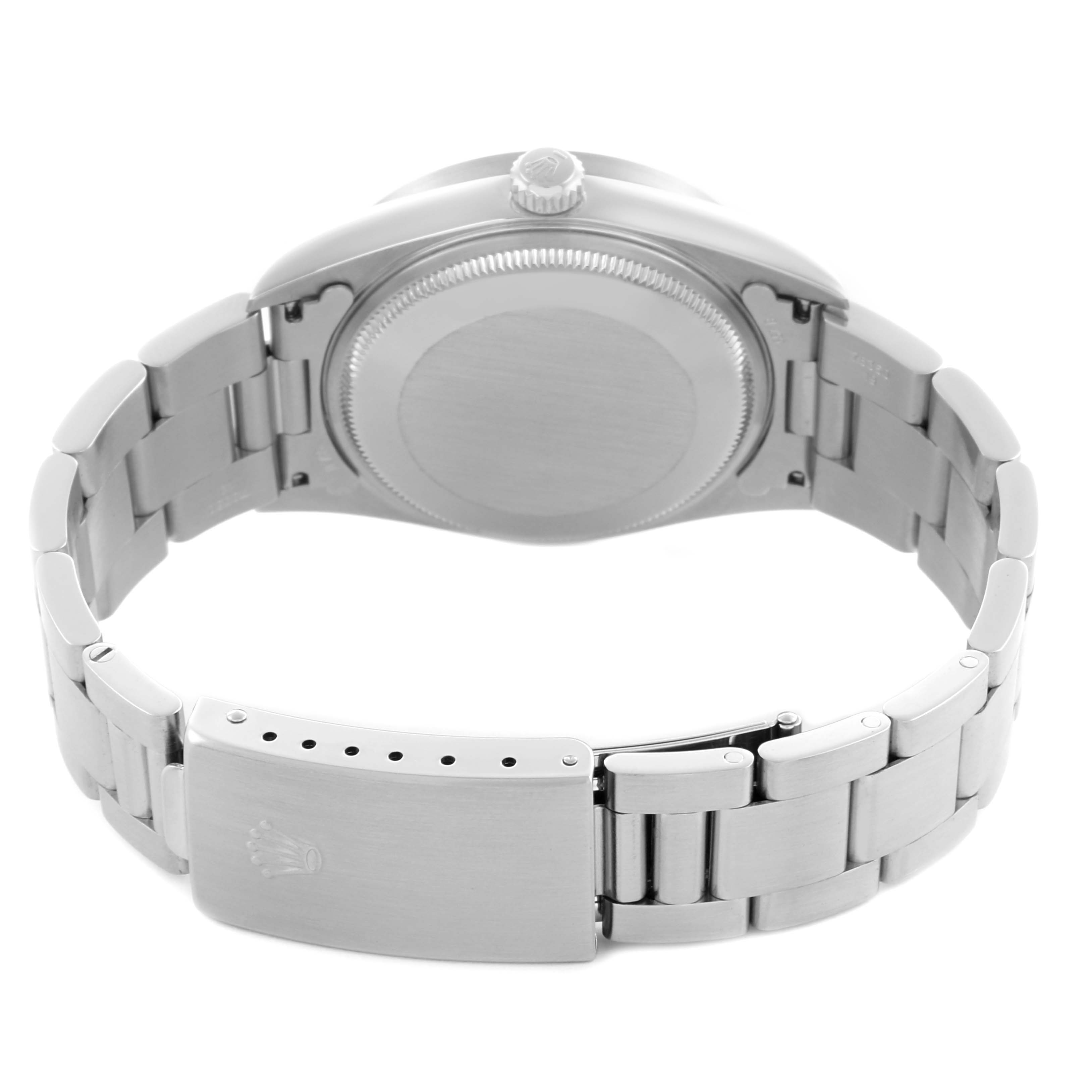 The image shows the back of a Rolex Datejust watch, highlighting the case back, bracelet, and clasp.