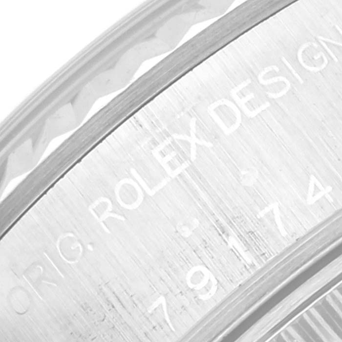 The image shows a close-up of the engraved side of the case of a Rolex Datejust 79174 Women's Stainless Steel Silver Dial 79174 Women's Stainless Steel Silver Dial watch.