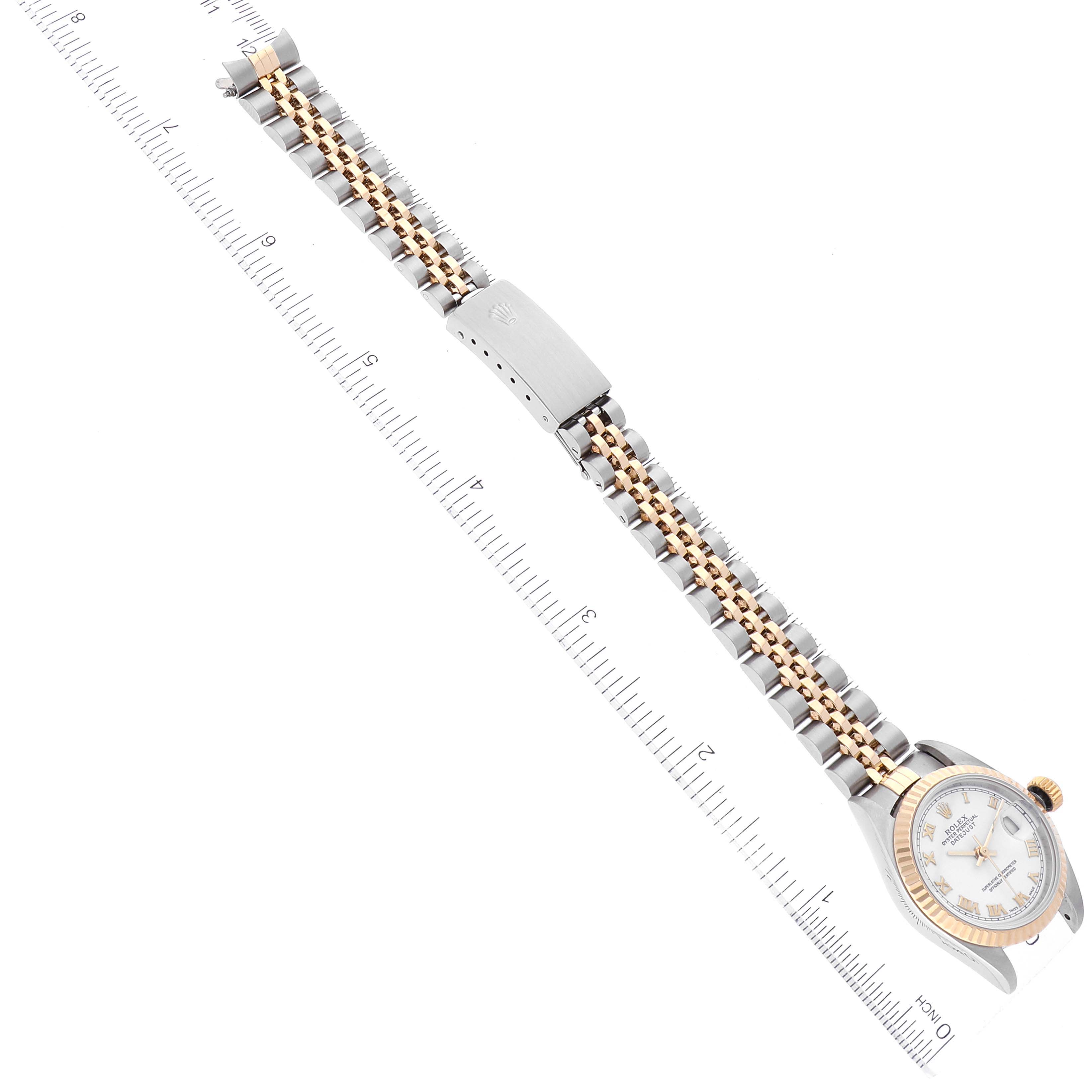 The image shows a Rolex Datejust 79173 Women's Steel and Gold (two tone) White Dial 79173 Women's Steel and Gold (two tone) White Dial watch laid flat with its bracelet fully extended, next to a measurement ruler.