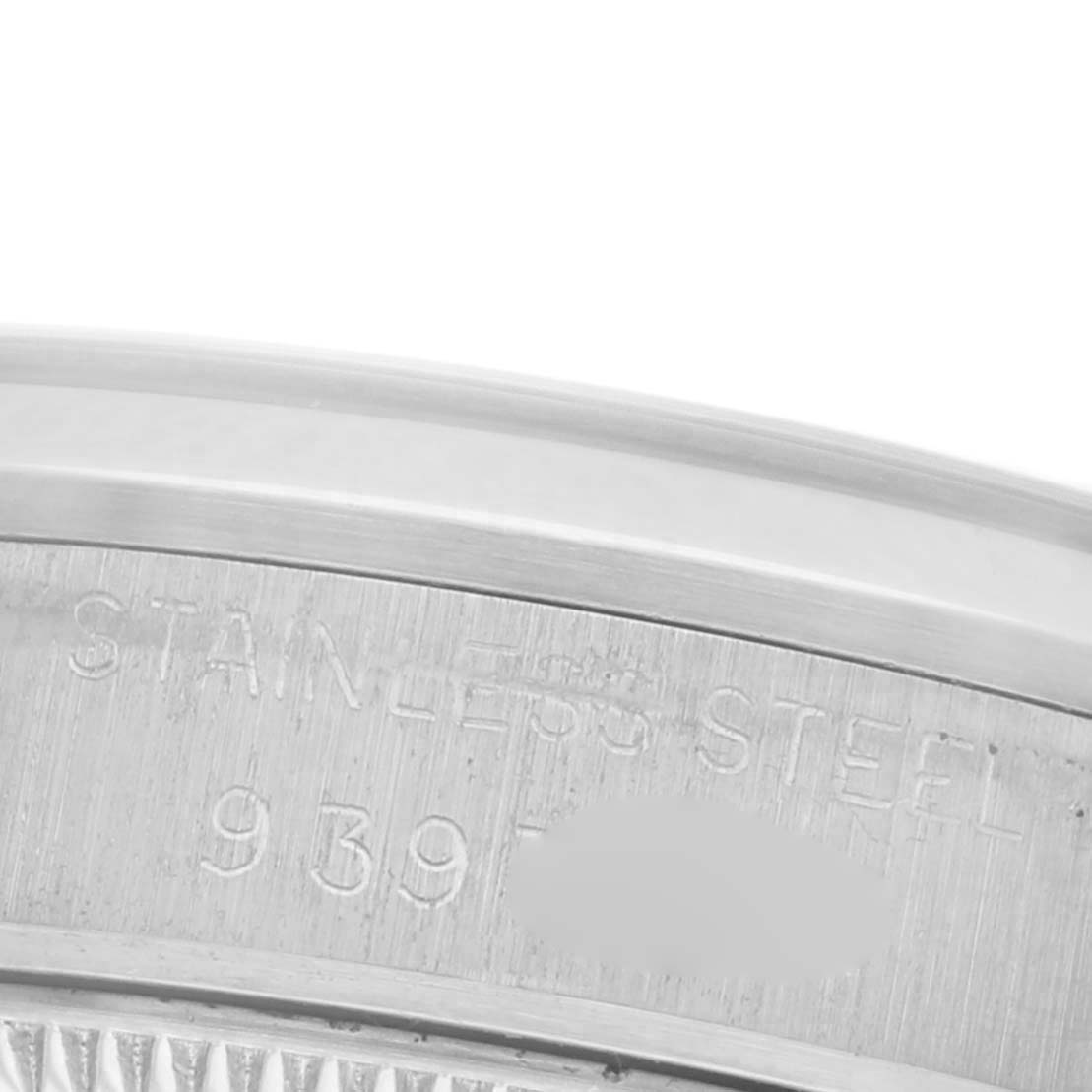 The image shows a close-up of the case back edge of a Rolex Mid-Size 68240 Women's Stainless Steel Blue Dial 68240 Women's Stainless Steel Blue Dial model, highlighting the stainless steel engraving and serial number area.