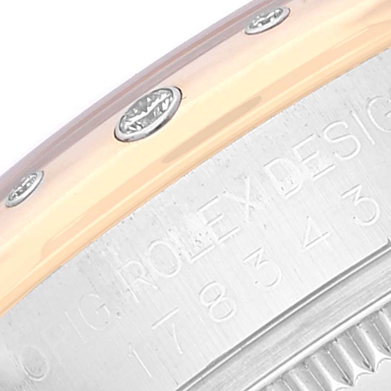 The image shows the watch case and bezel of a Rolex Mid-Size 178343 Women's Steel and Gold (two tone) White Dial 178343 Women's Steel and Gold (two tone) White Dial model, displaying the brand engraving and partial serial number.