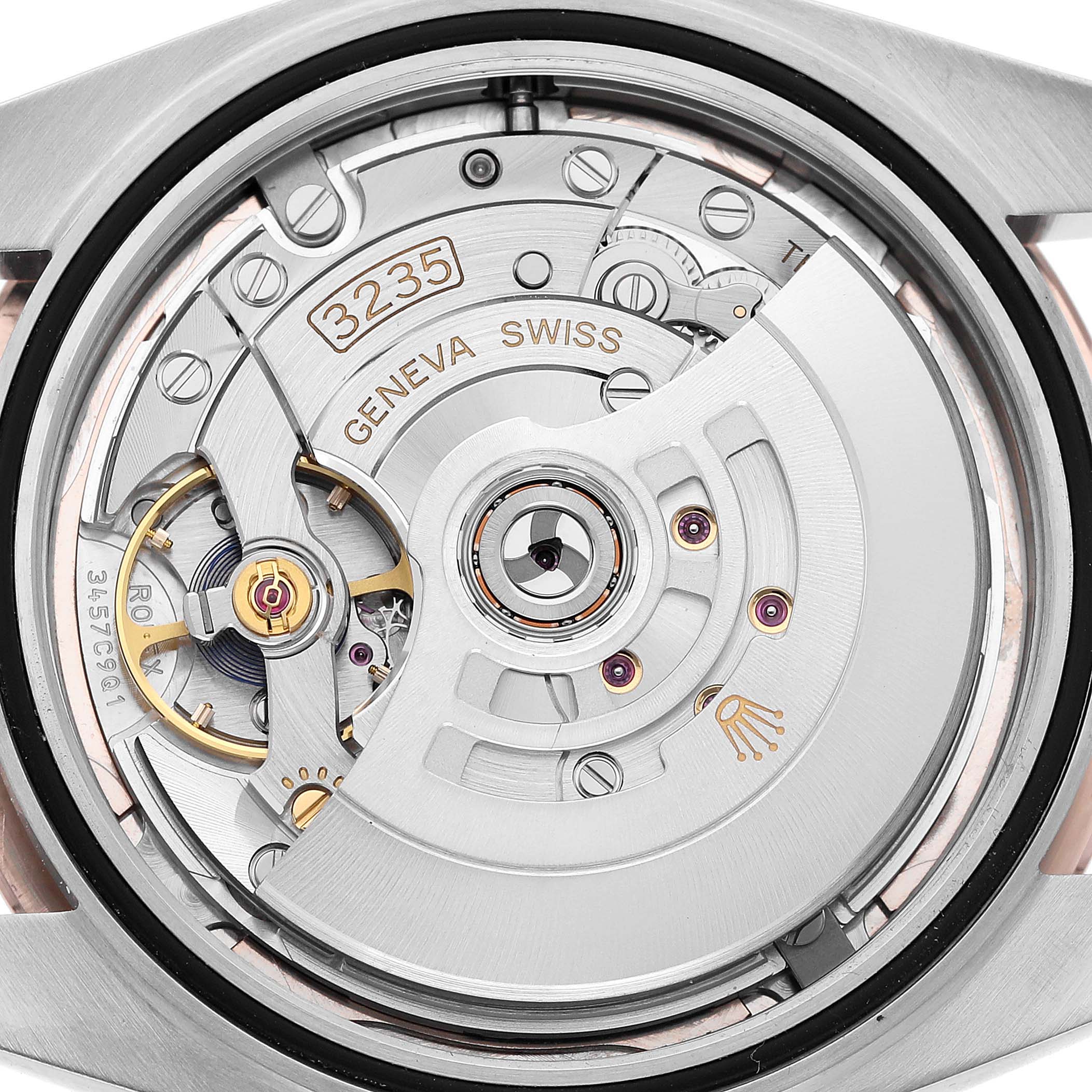 The image shows the movement of a Rolex Datejust 126301 Men's Steel and Gold (two tone) Pink Dial watch from a rear angle, highlighting its intricate internal mechanisms.