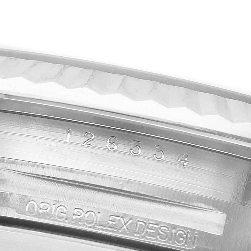 The image shows an angled close-up of the Rolex Datejust 41 126334 Men's Stainless Steel Grey Dial case's engraved reference number and "ORIG ROLEX DESIGN."
