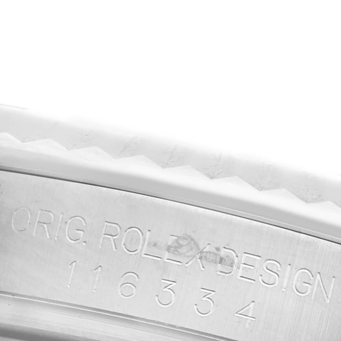 The image shows an angled close-up of the Rolex Datejust 41 116334 Men's Stainless Steel White Dial 116334 Men's Stainless Steel White Dial, focusing on the case edge with engraved serial numbers.