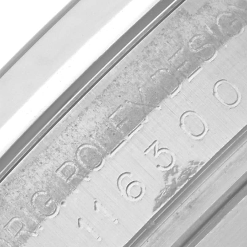 The image shows an angled view of the Rolex Datejust 41 116300 Men
s Stainless Steel Silver Dial 116300 Men
s Stainless Steel Silver Dial
s inner bezel with engraved text and numbers.