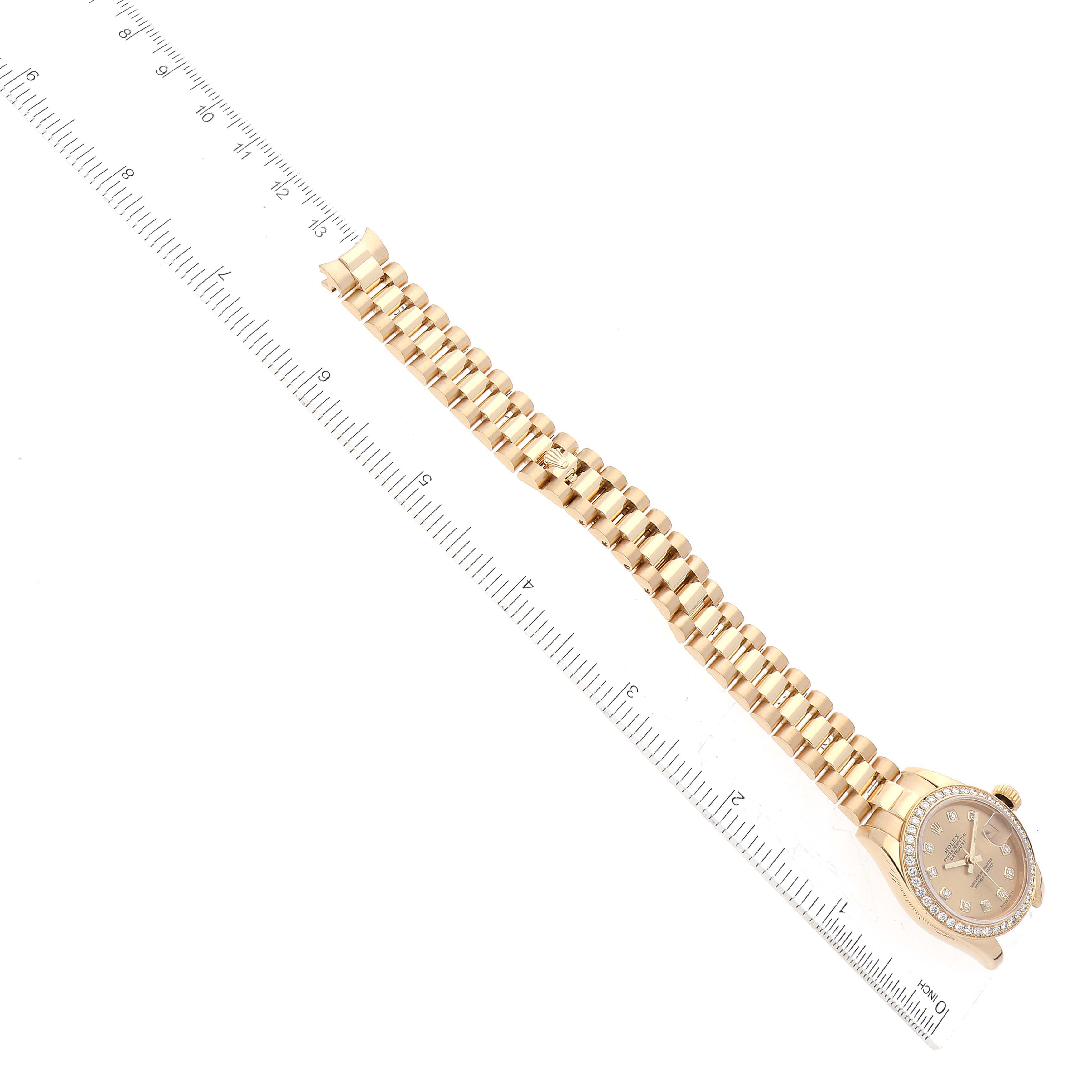 This image shows an overhead view of a Rolex President 179138 Women
s Yellow Gold Champagne Dial 179138 Women
s Yellow Gold Champagne Dial model watch, highlighting its bracelet and face with a ruler for scale.