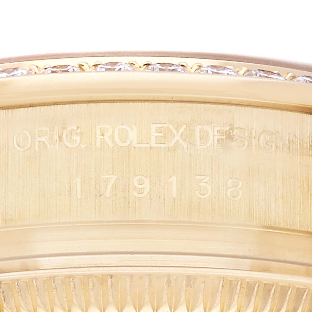 This close-up image shows the engraved serial number on the side of the bezel of a Rolex President 179138 Women
s Yellow Gold Champagne Dial 179138 Women
s Yellow Gold Champagne Dial watch.