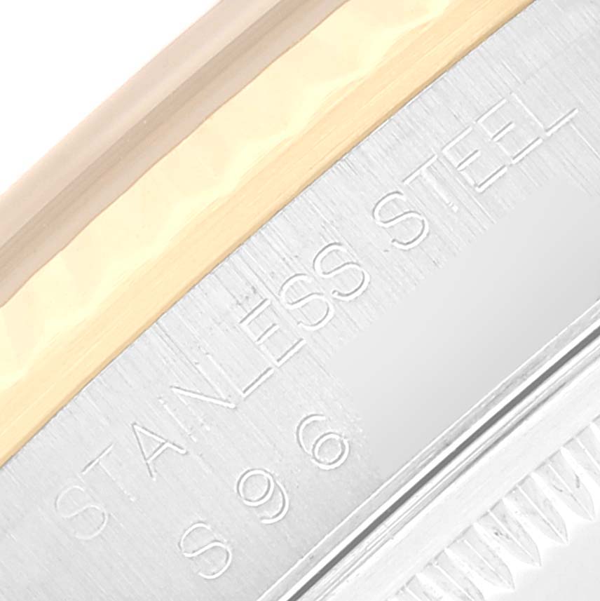 Close-up of the Rolex Datejust 16233 Men's Steel and Gold (two tone) Blue Dial 16233 Men's Steel and Gold (two tone) Blue Dial, showing the edge of the bezel with "STAINLESS STEEL" engraving.