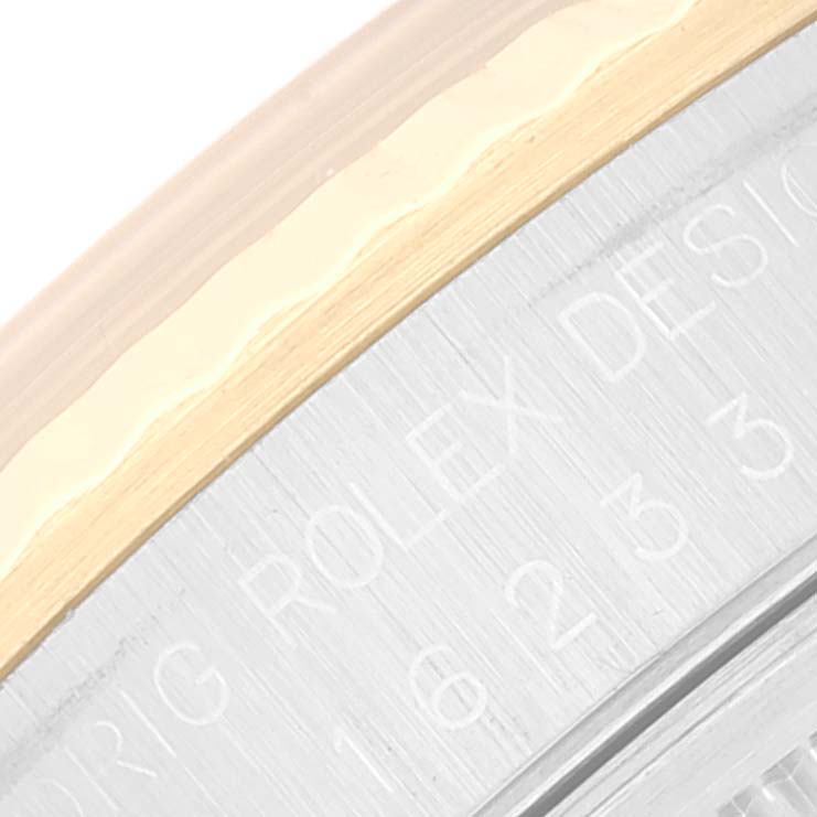 The image shows a close-up of the Rolex Datejust 16233 Men's Steel and Gold (two tone) Blue Dial 16233 Men's Steel and Gold (two tone) Blue Dial's case back and the engraved text "ROLEX DESIGN".