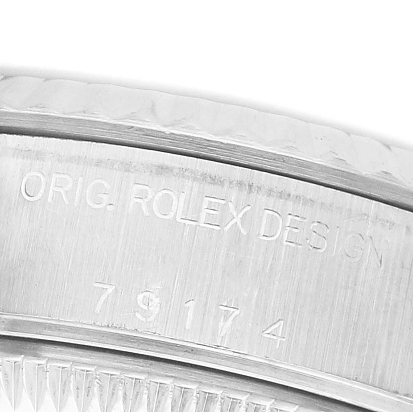 The image shows an angled close-up of the case side of a Rolex Datejust 79174 Women's Stainless Steel Silver Dial, revealing the "ORIG. ROLEX DESIGN" engraving.